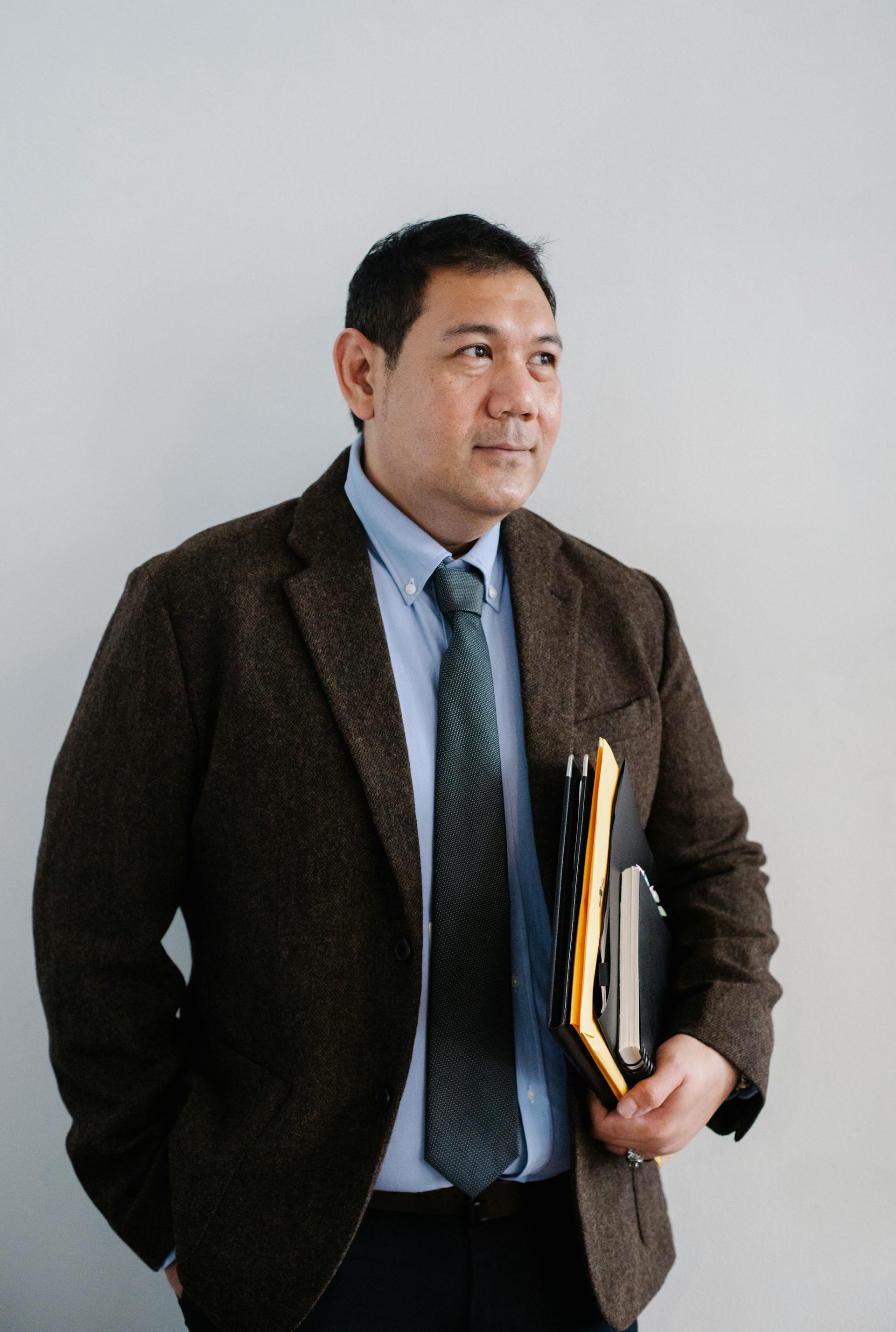 A lawyer standing with his files | Source: Pexels