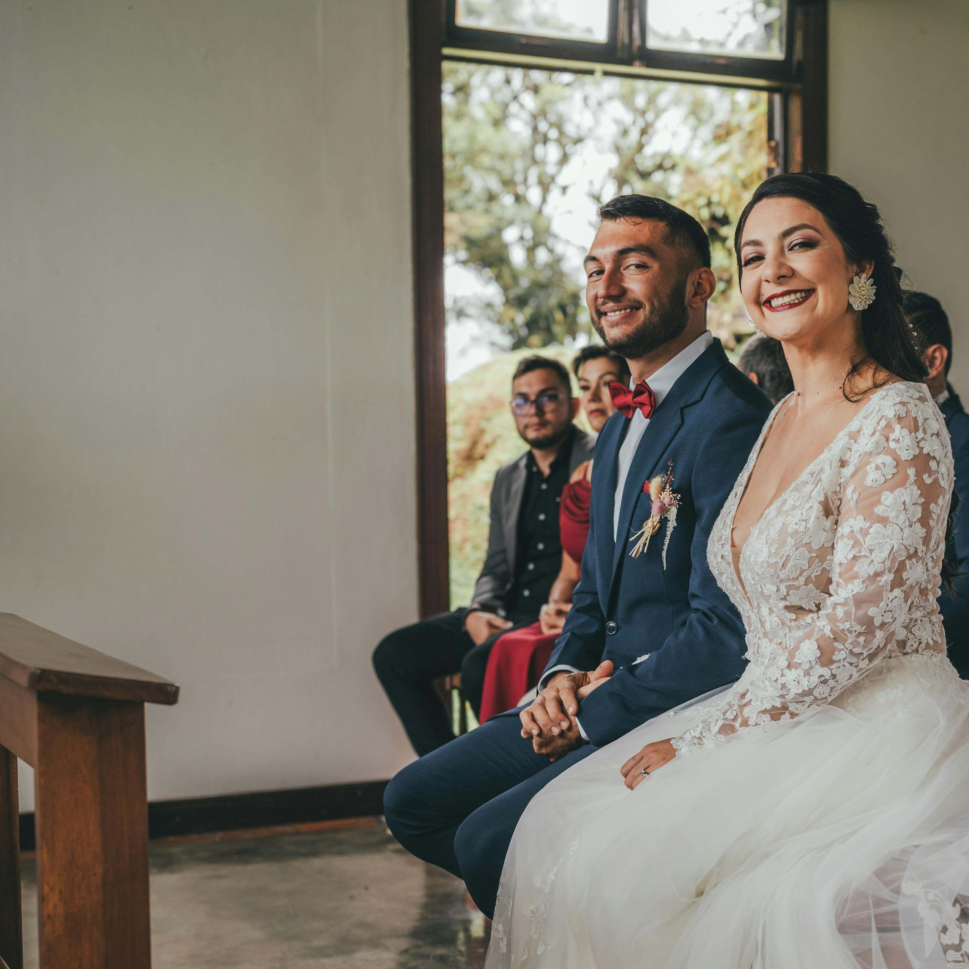 A bride and groom smiling in front of the altar | Source: Pexels