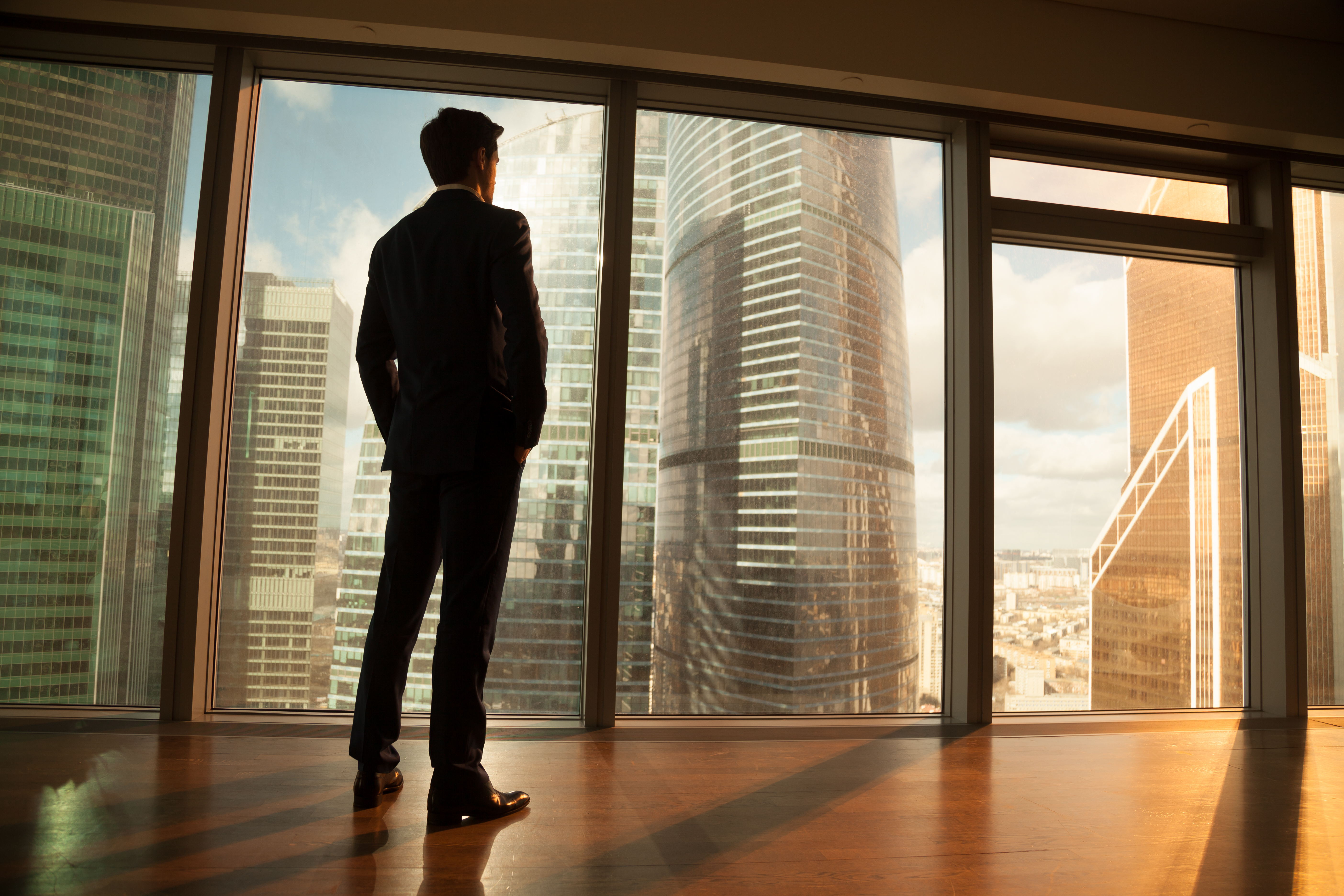 A man standing in an empty office space | Source: Shutterstock