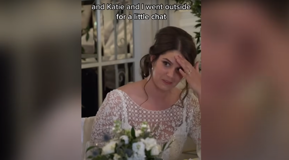 Katie holding her head in embarrassment during her groom Ian Young's speech | Source: YouTube / Daily Record