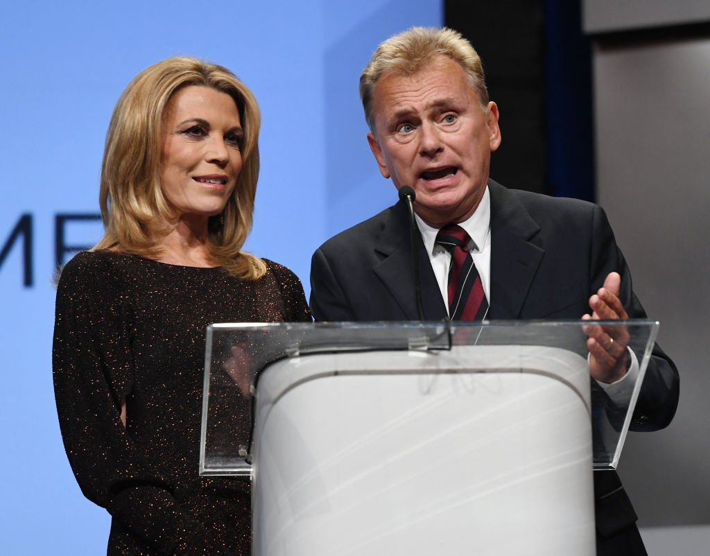 "Wheel of Fortune" hostess Vanna White (L) and host Pat Sajak speak as they are inducted into the National Association of Broadcasters Broadcasting Hall of Fame during the NAB Achievement in Broadcasting Dinner at the Encore Las Vegas | Photo: Getty Images