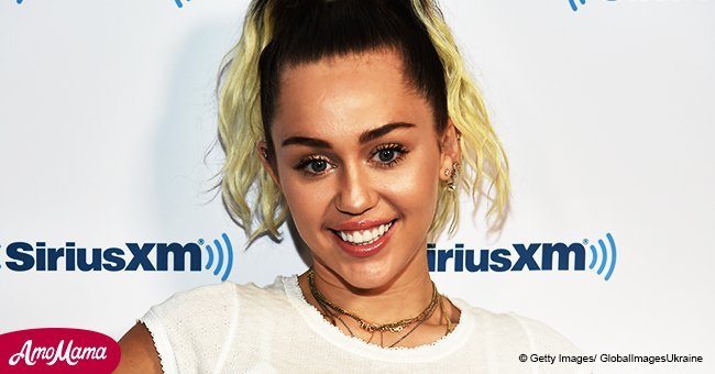 Miley Cyrus, 25, flaunts her gorgeous cleavage in a very low-cut dress as she shared new photos