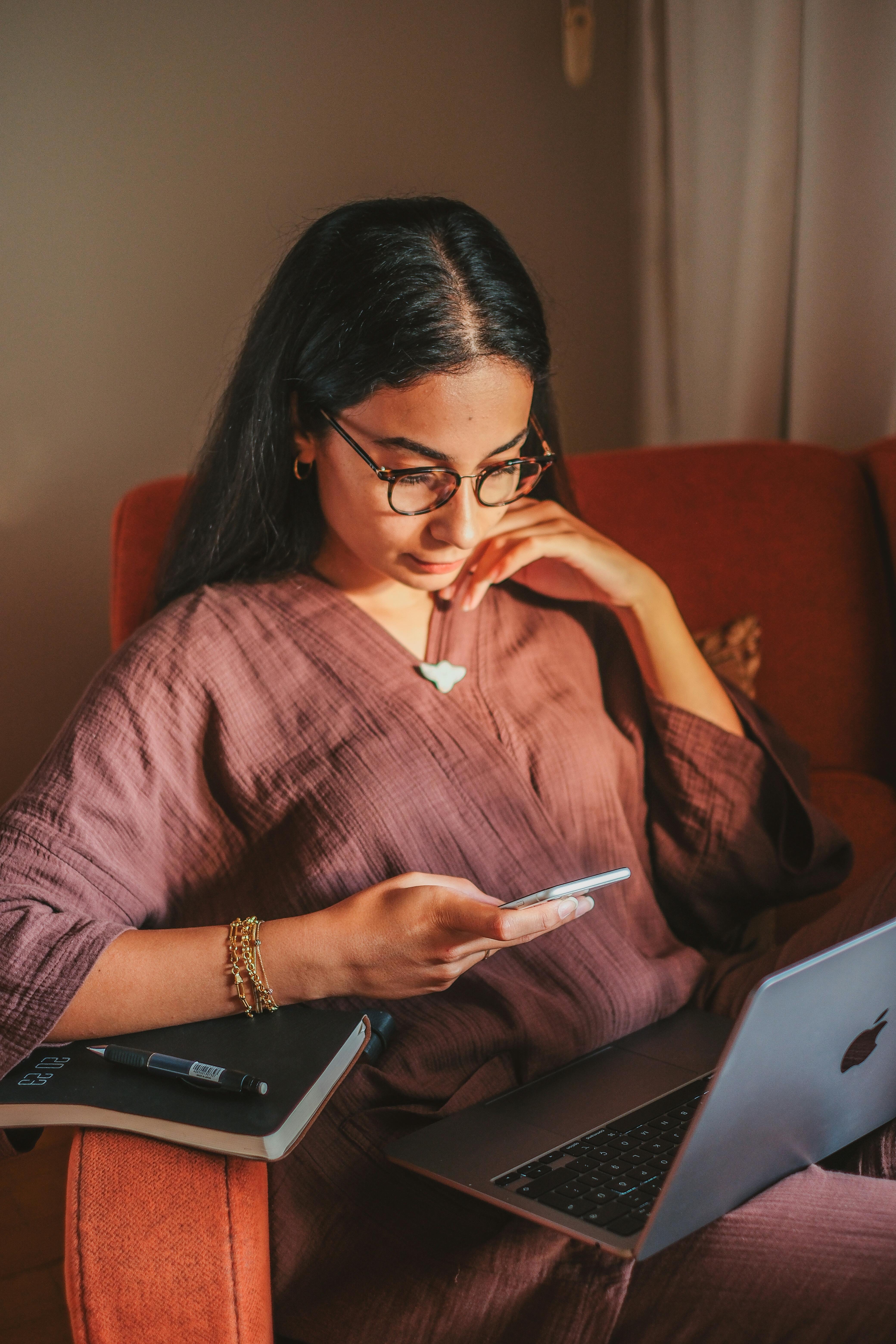 A woman looking at her phone | Source: Pexels