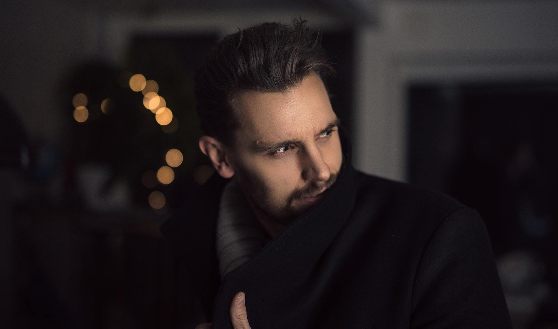 A man in a black coat looking at someone | Source: Pexels