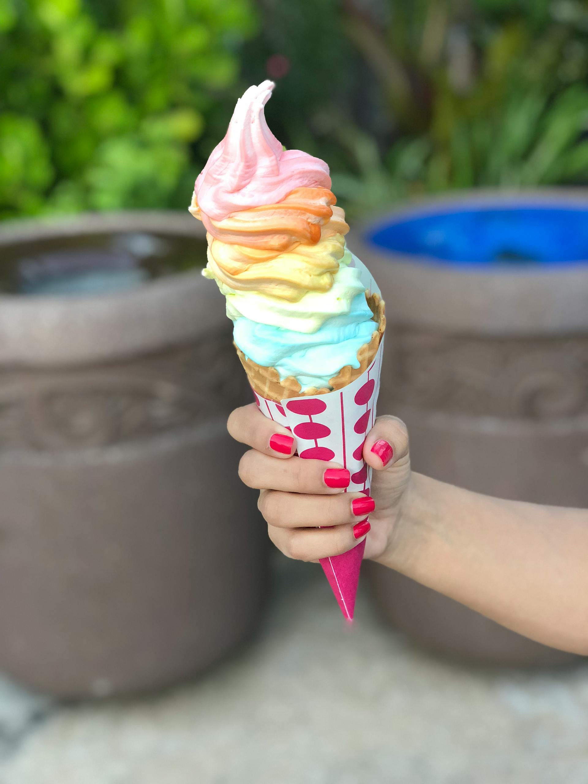 Close-up of a woman holding an ice cream cone | Source: Pexels