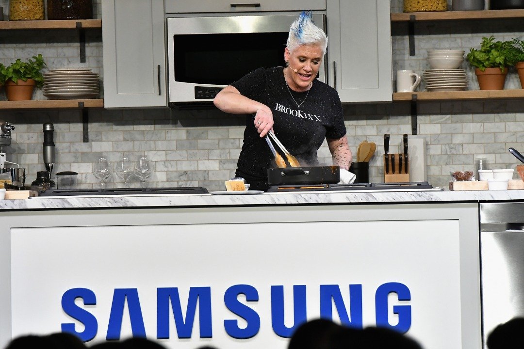  Anne Burrell prepares a plate at the Food Network & Cooking Channel New York City Wine & Food Festival presented by Coca-Cola grand tasting presented by ShopRite featuring Samsung® culinary demonstrations presented by Mastercard at Pier 94 on October 14, 2017. | Source: Getty Images