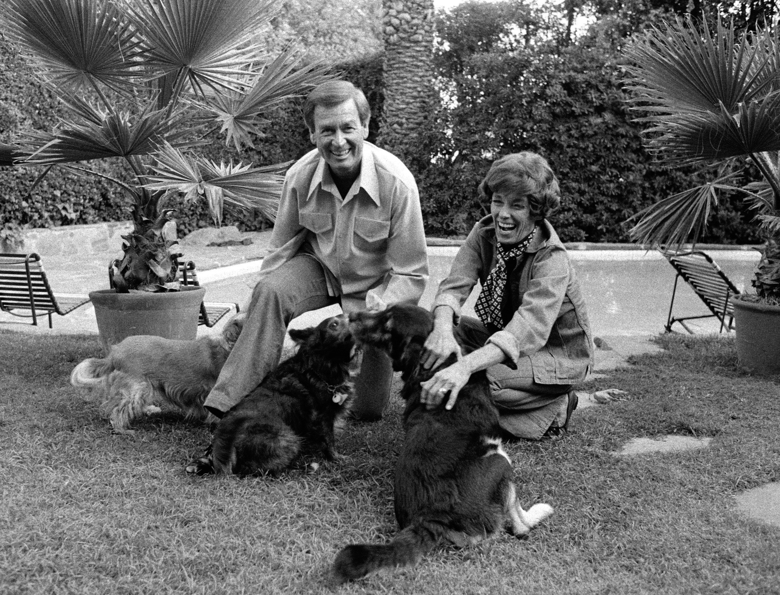 American game show host Bob Barker and his wife Dorothy Jo (1924 - 1981) play with three dogs in their back yard, November 4, 1977. | Source: Getty Images