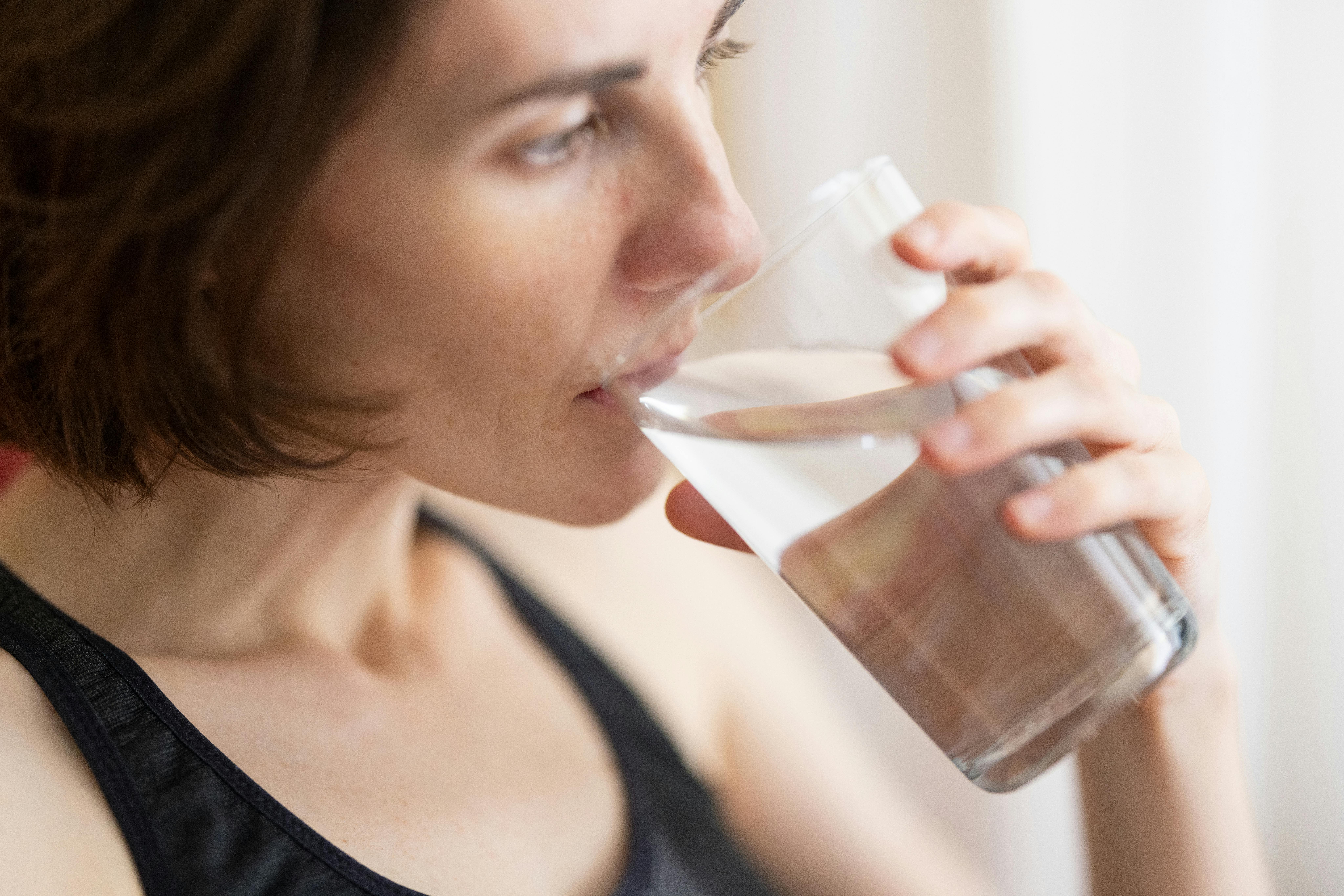 A woman drinking water | Source: Pexels