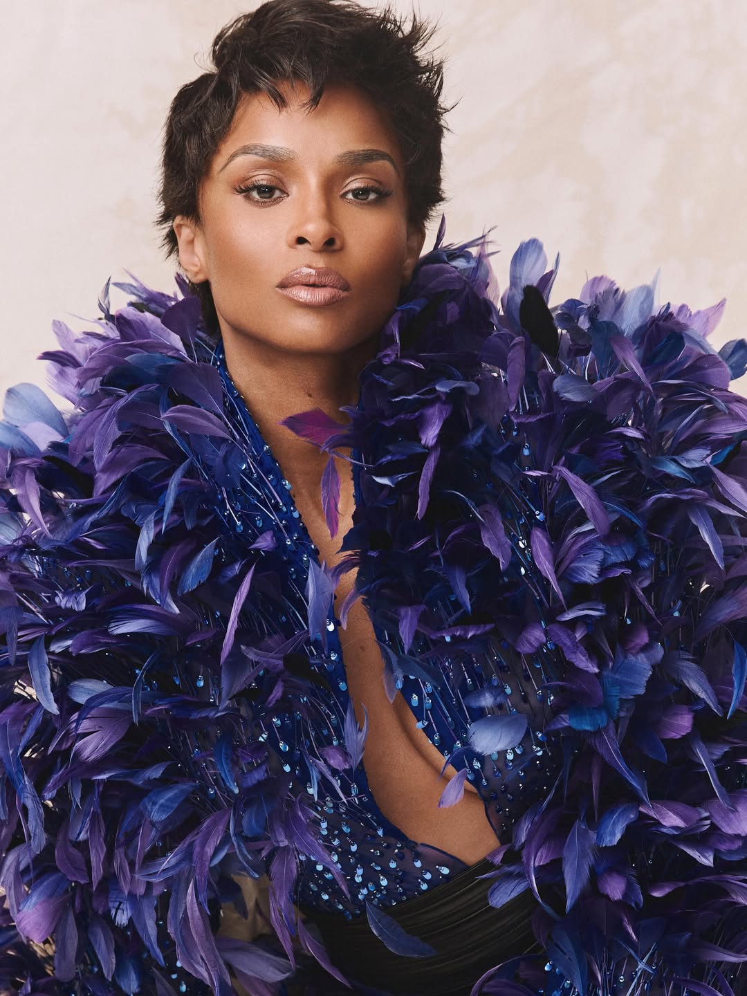 A feathered look frames Ciara in a striking close-up portrait | Source: Instagram/ciara