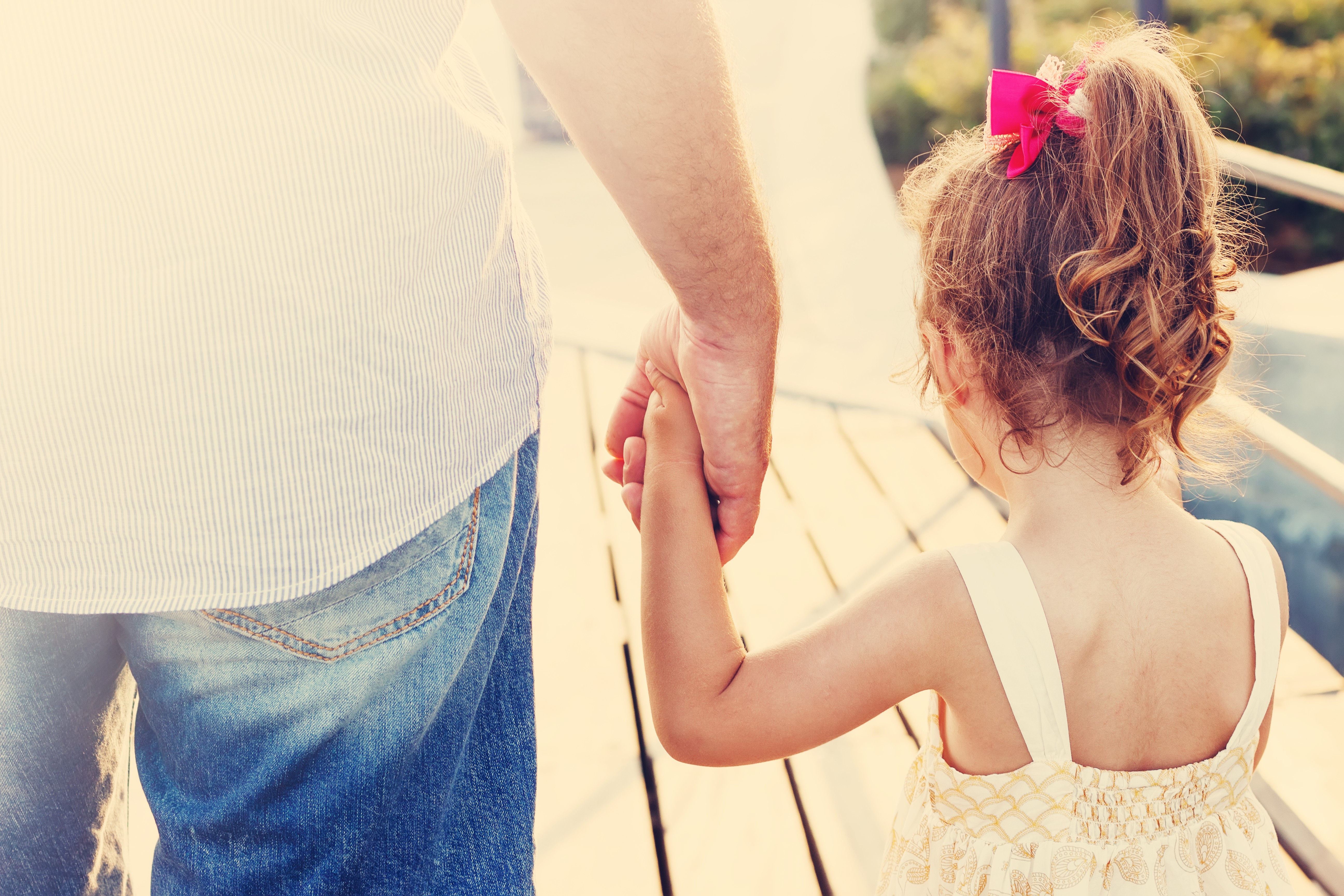 Father and daughter holding hands | Source: Shutterstock