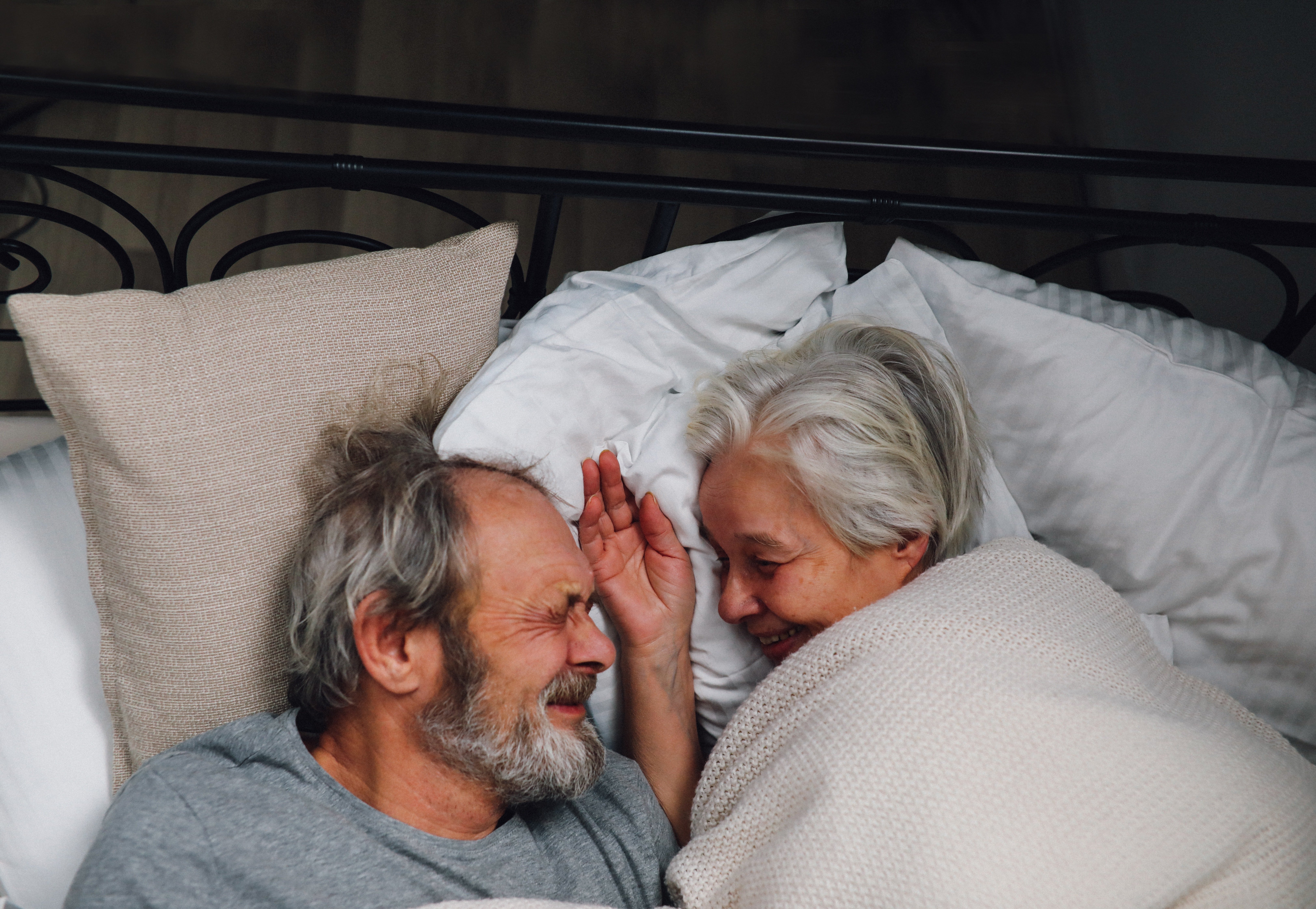 An elderly couple couddling in bed. Source: Pexels/ Tom Leishman
