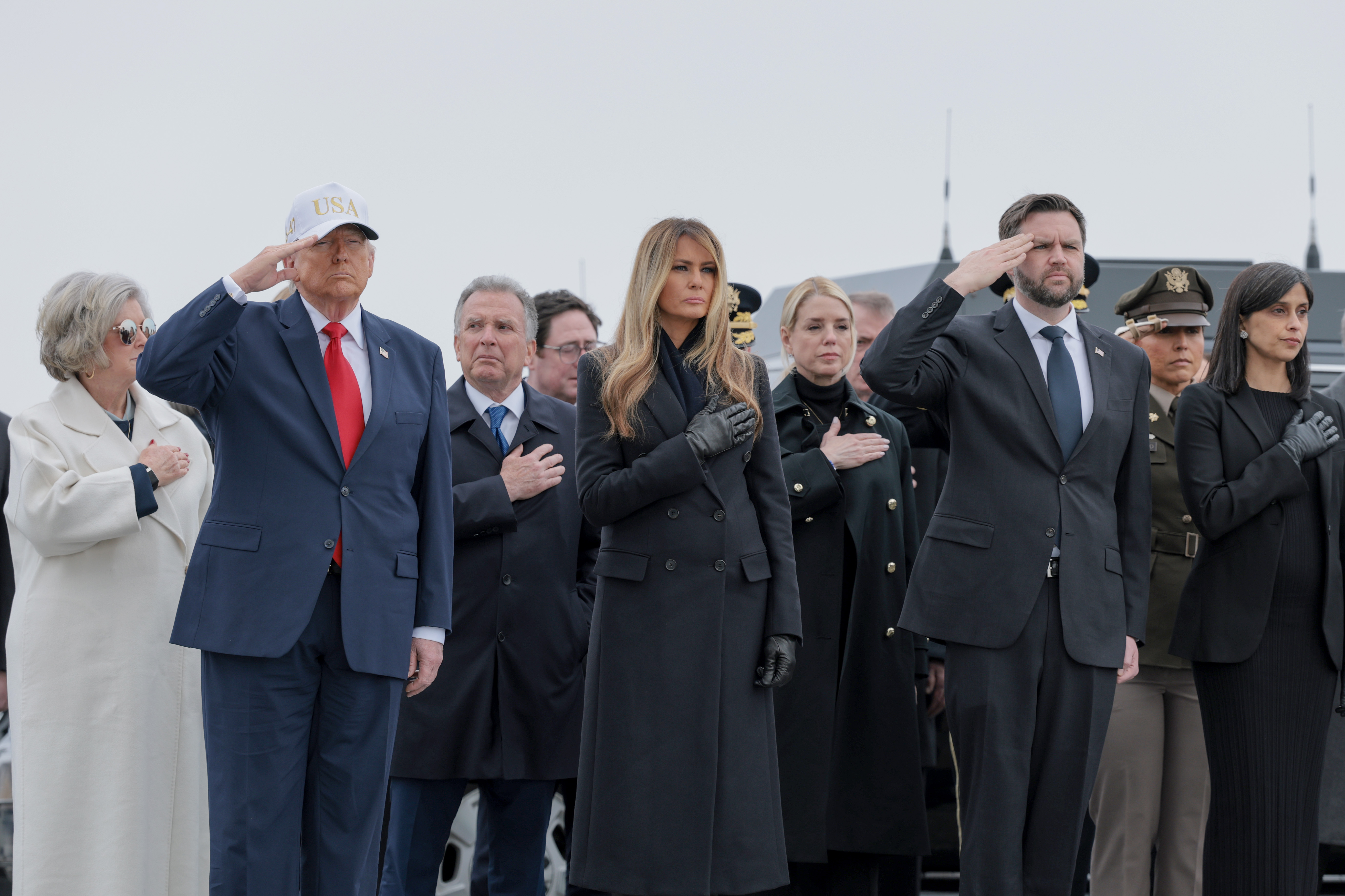 White House Chief of Staff Susie Wiles, U.S. President Donald Trump, U.S. Special Envoy to the Middle East Steve Witkoff, First Lady Melania Trump, U.S. Attorney General Pam Bondi, Vice President JD Vance, and Second Lady Usha Vance stand at attention during a dignified transfer at Dover Air Force Base March 7, 2026 in Dover, Delaware | Source: Getty Images
