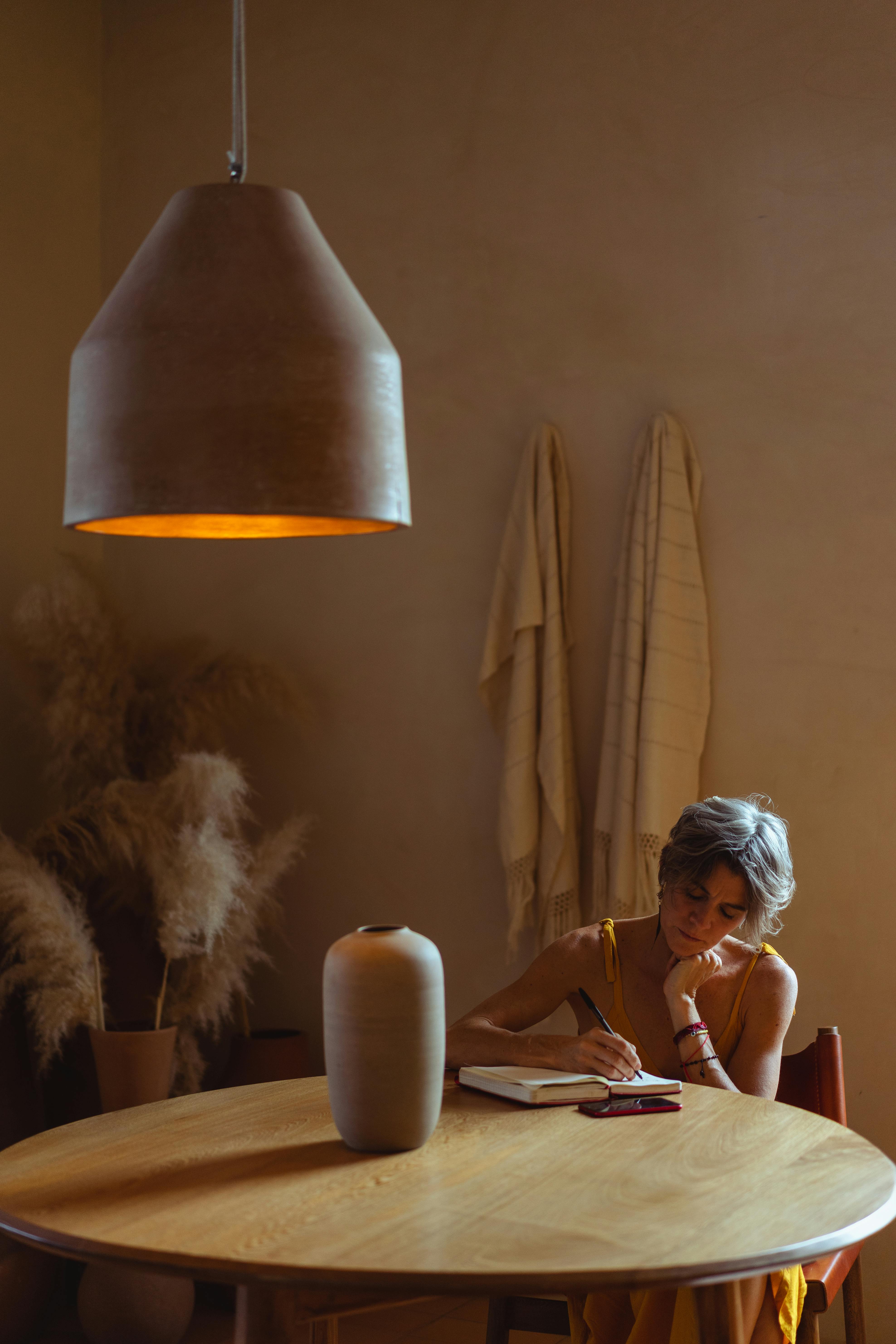 A woman writing a letter | Source: Pexels