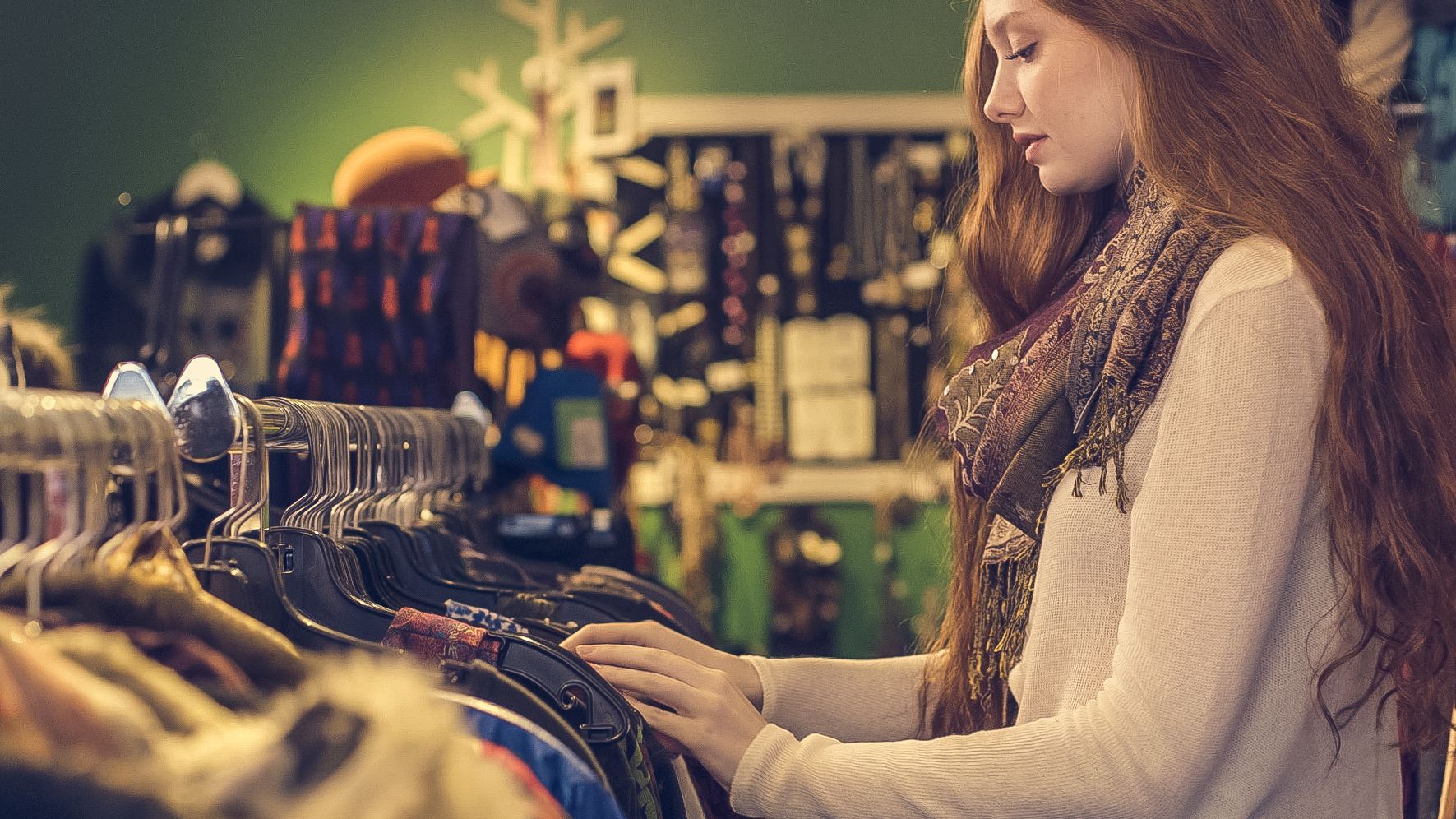 A woman browses clothing racks at a store. | Source: Pexels