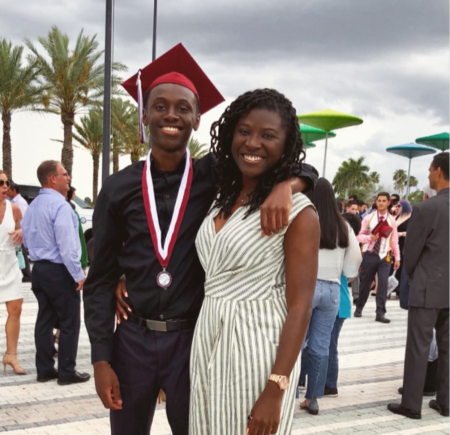 Smiling proudly at a graduation celebration, Nancy Metayer Bowen stands beside her brother, Donovan Metayer, as he wears his cap and medal, the pair sharing a joyful, close embrace amid the festive crowd. | Source: Instagram/nancymetayerbowen