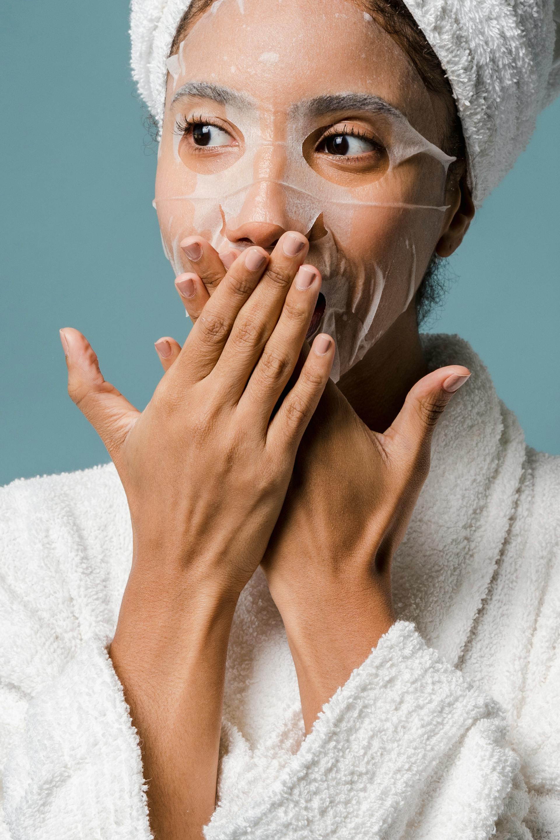 A woman covering her mouth with her hands | Source: Pexels