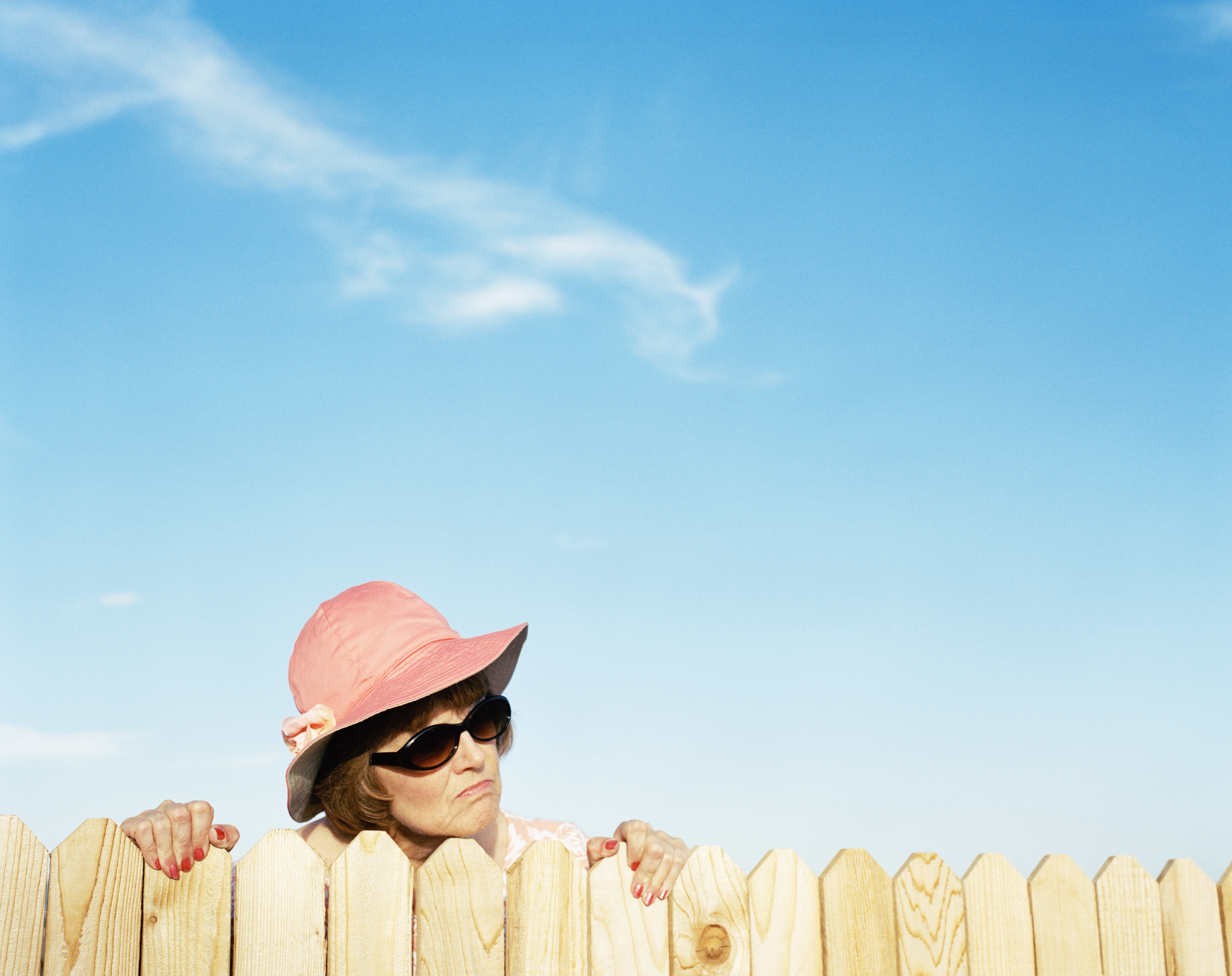 A mature woman looking over the fence | Source: Getty Images
