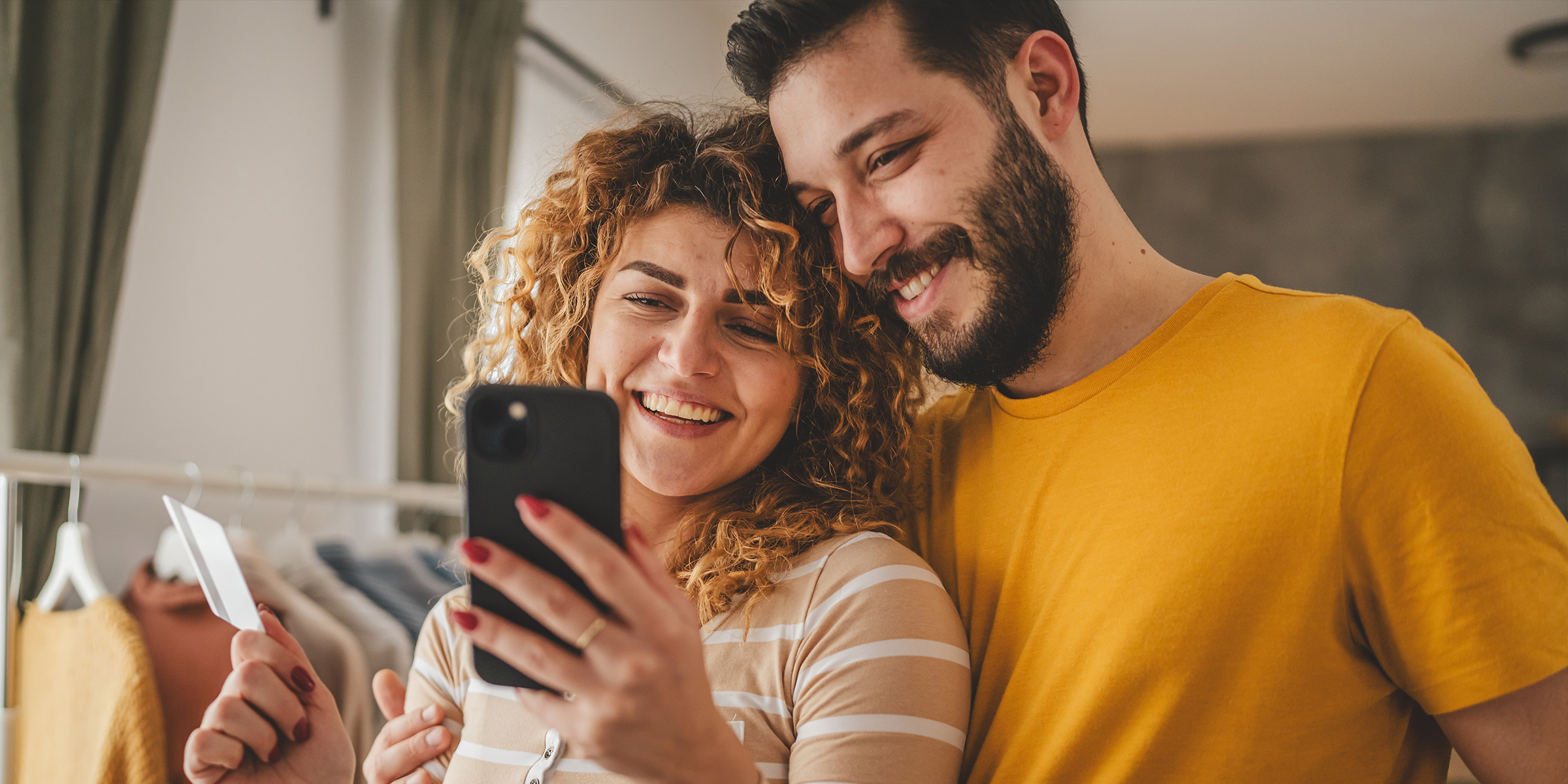 A couple smiling at a phone | Source: Shutterstock