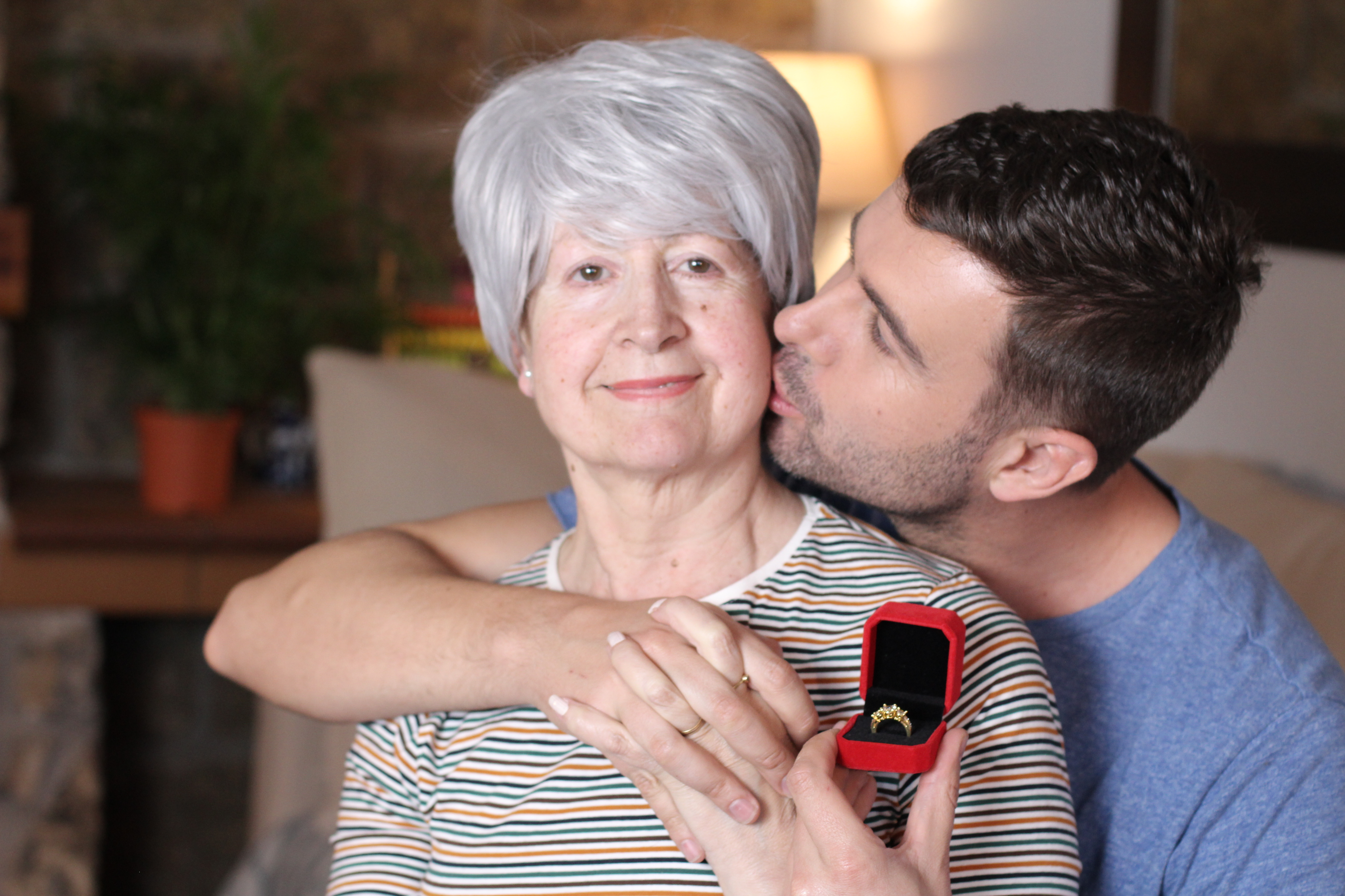 A young man kissing an older woman on the cheek | Source: Shutterstock