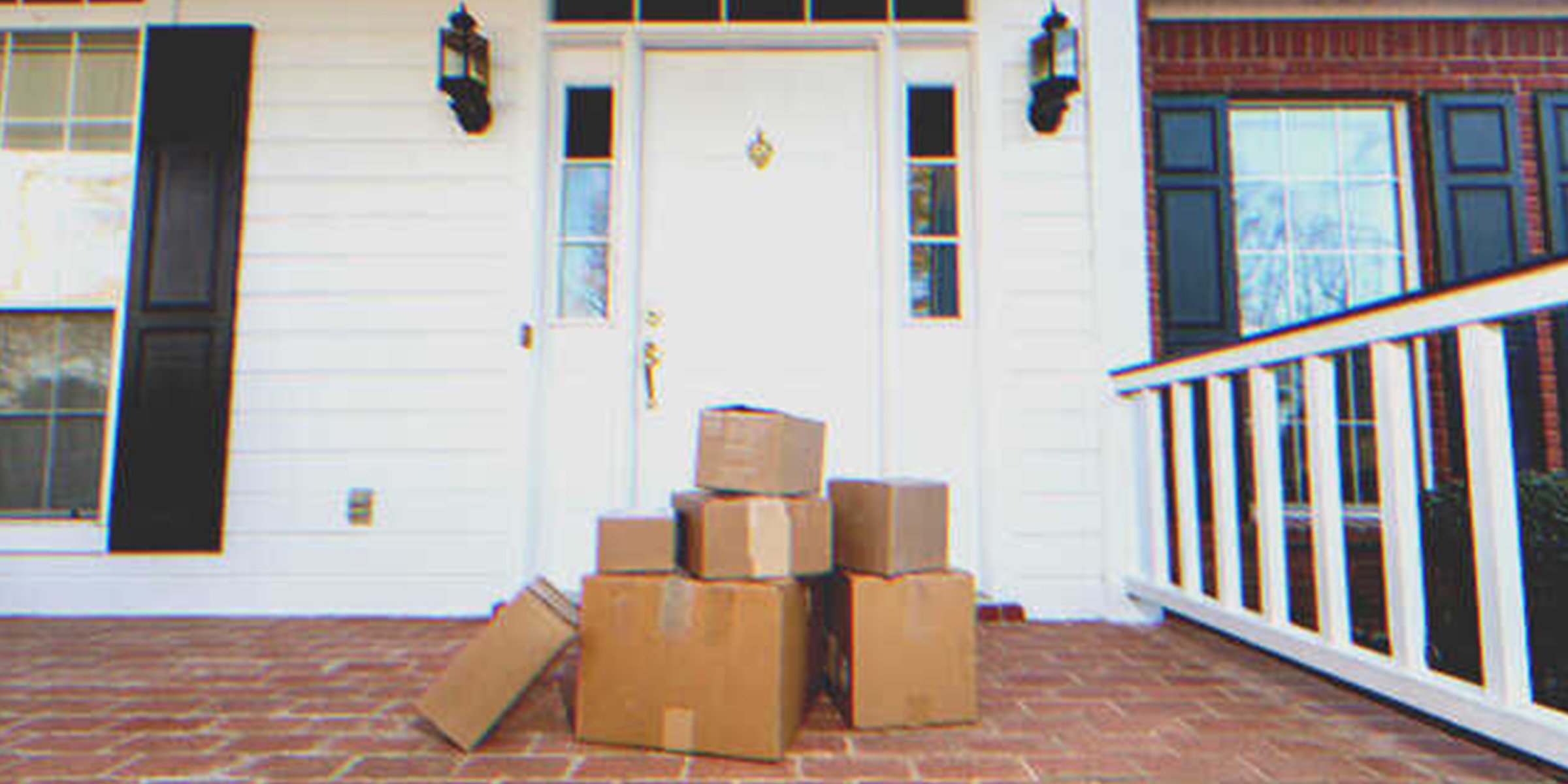 Some boxes in front of a house's door | Source: Shutterstock