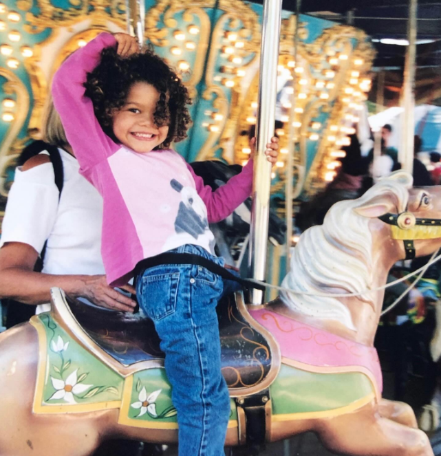 Across the pond, another young person would soon become a star. In this photo, she posed while playing on a carousel in a throwback image uploaded on September 1, 2025. | Source: Instagram/zendaya