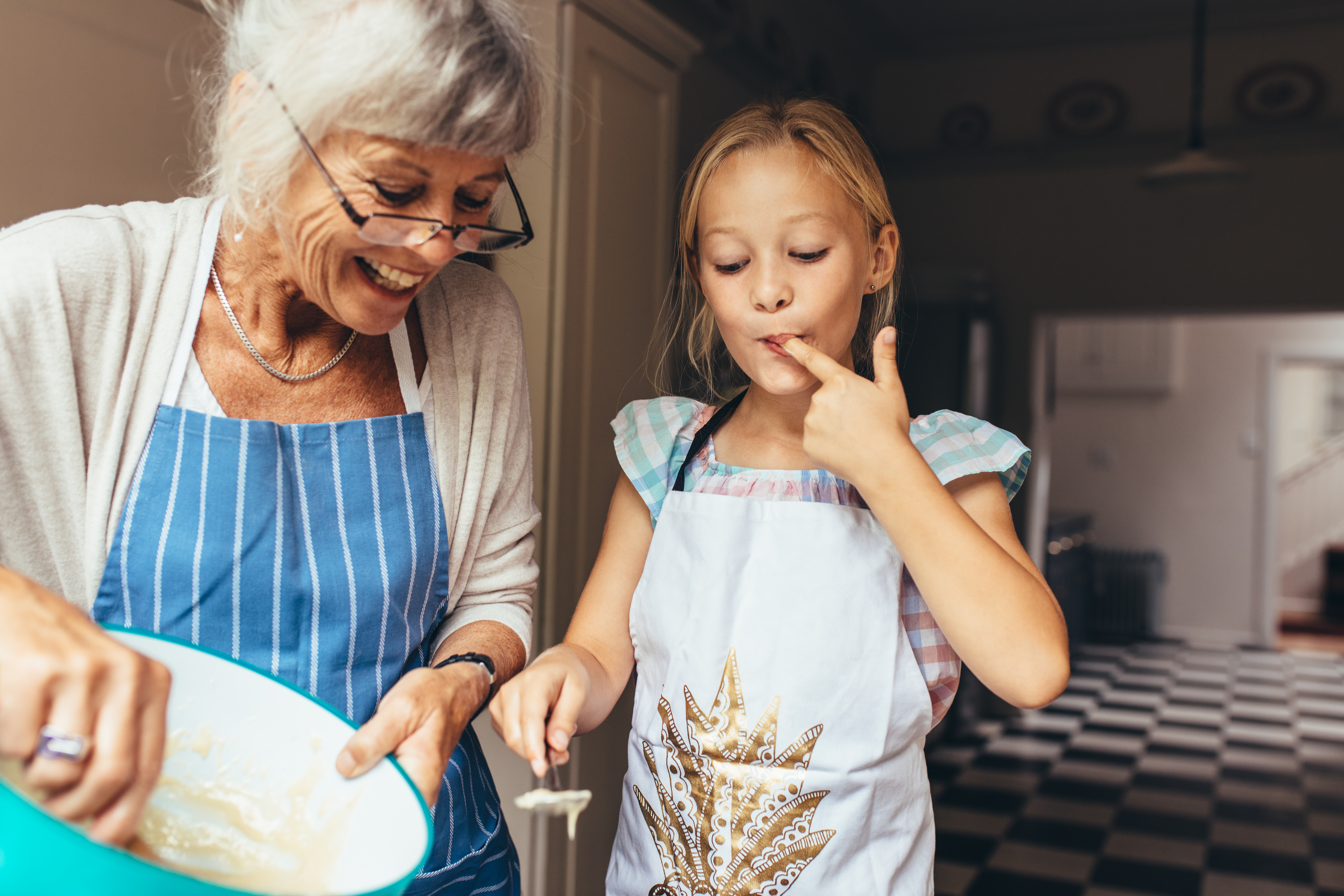 A little girl and her grandmother baking | Source: Shutterstock