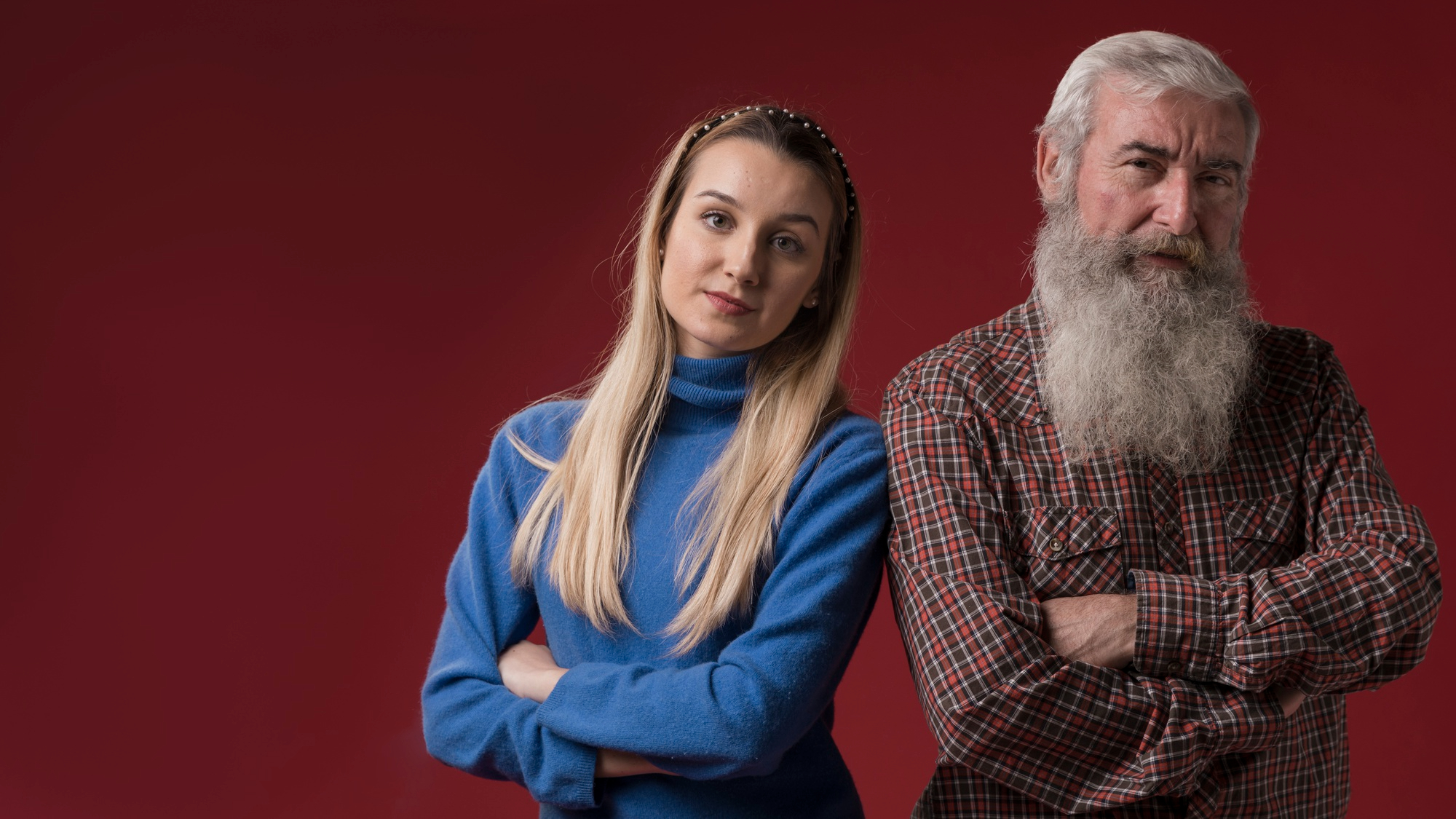 A father and his daughter standing with folded arms | Source: Freepik