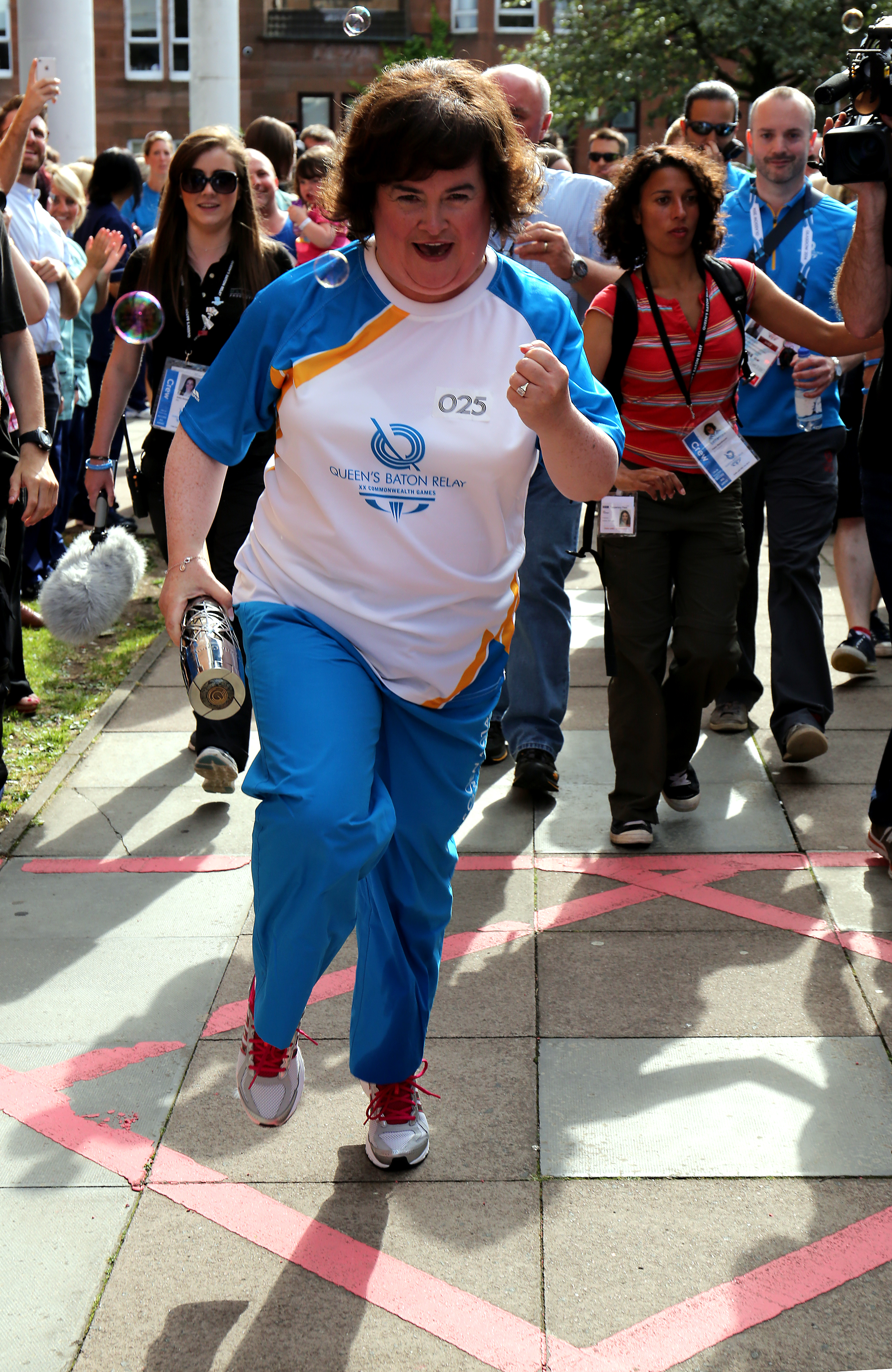 Susan Boyle passes on the Glasgow 2014 Queen's Baton on July 21, 2014 in Scotland | Source: Getty Images