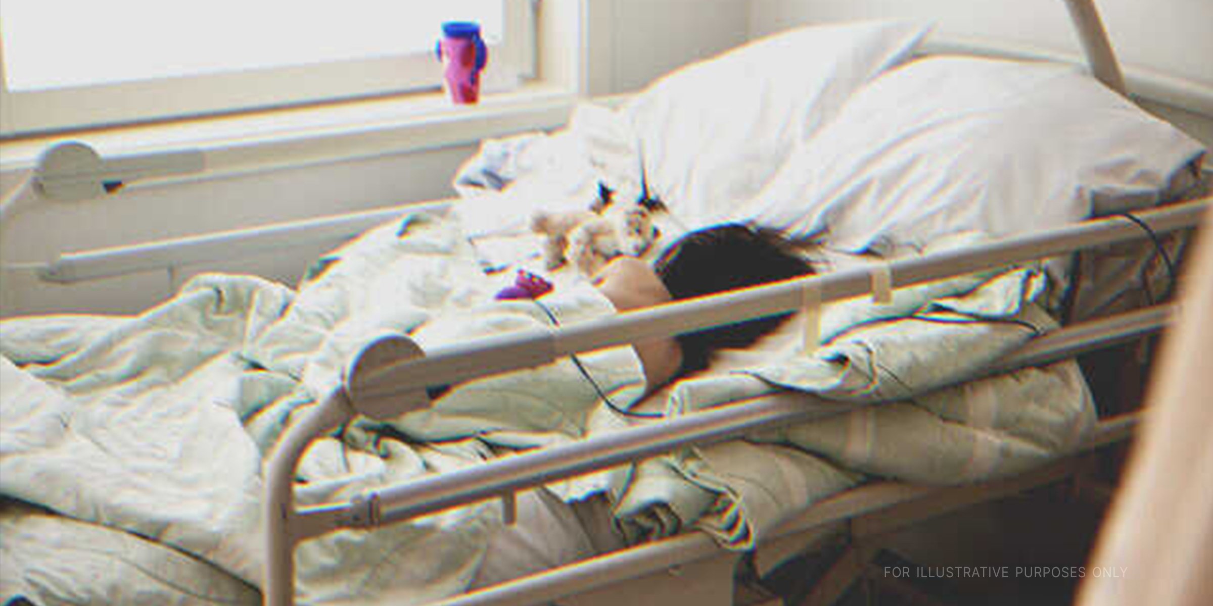 A sick child in a hospital bed. | Getty Images