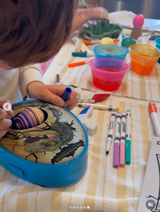 Photo of Archie decorating an egg-shaped object with Lilibet, also working on a craft in the background, from a video dated April 6, 2026. | Source: Instagram/meghan