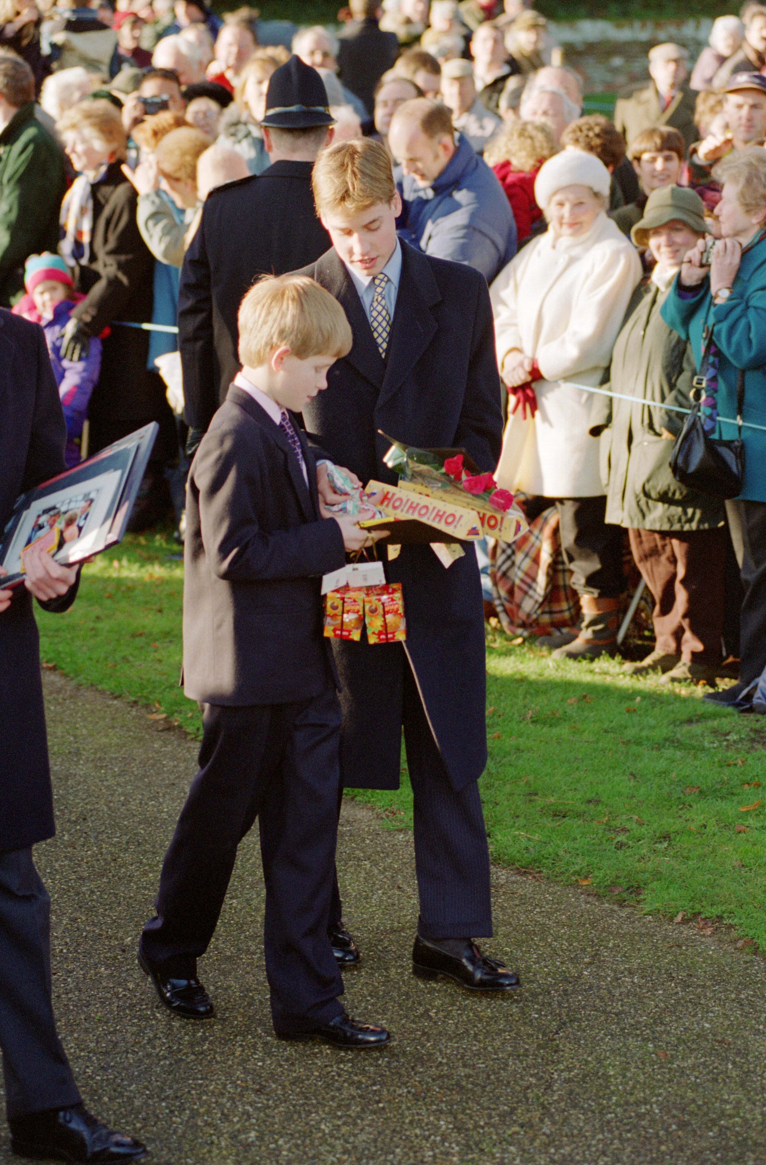 Prince William and Prince Harry pictured holding gifts at Sandringham Church on Christmas Day. / Source: Getty Images