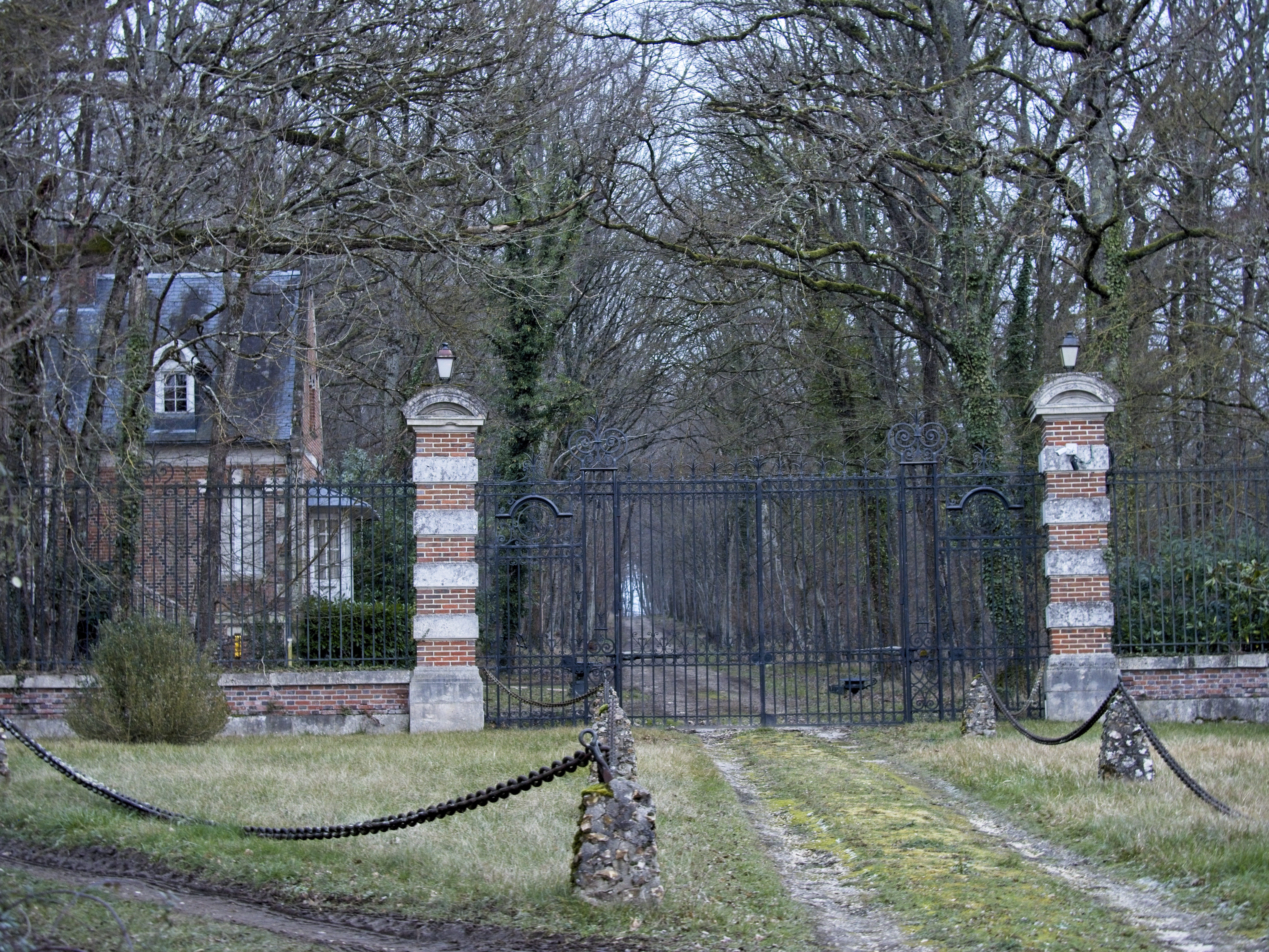 This photograph taken on January 16, 2024, shows a view of an entrance of the residence of Alain Delon, named La Brulerie, in Douchy, central France. | Source: Getty Images