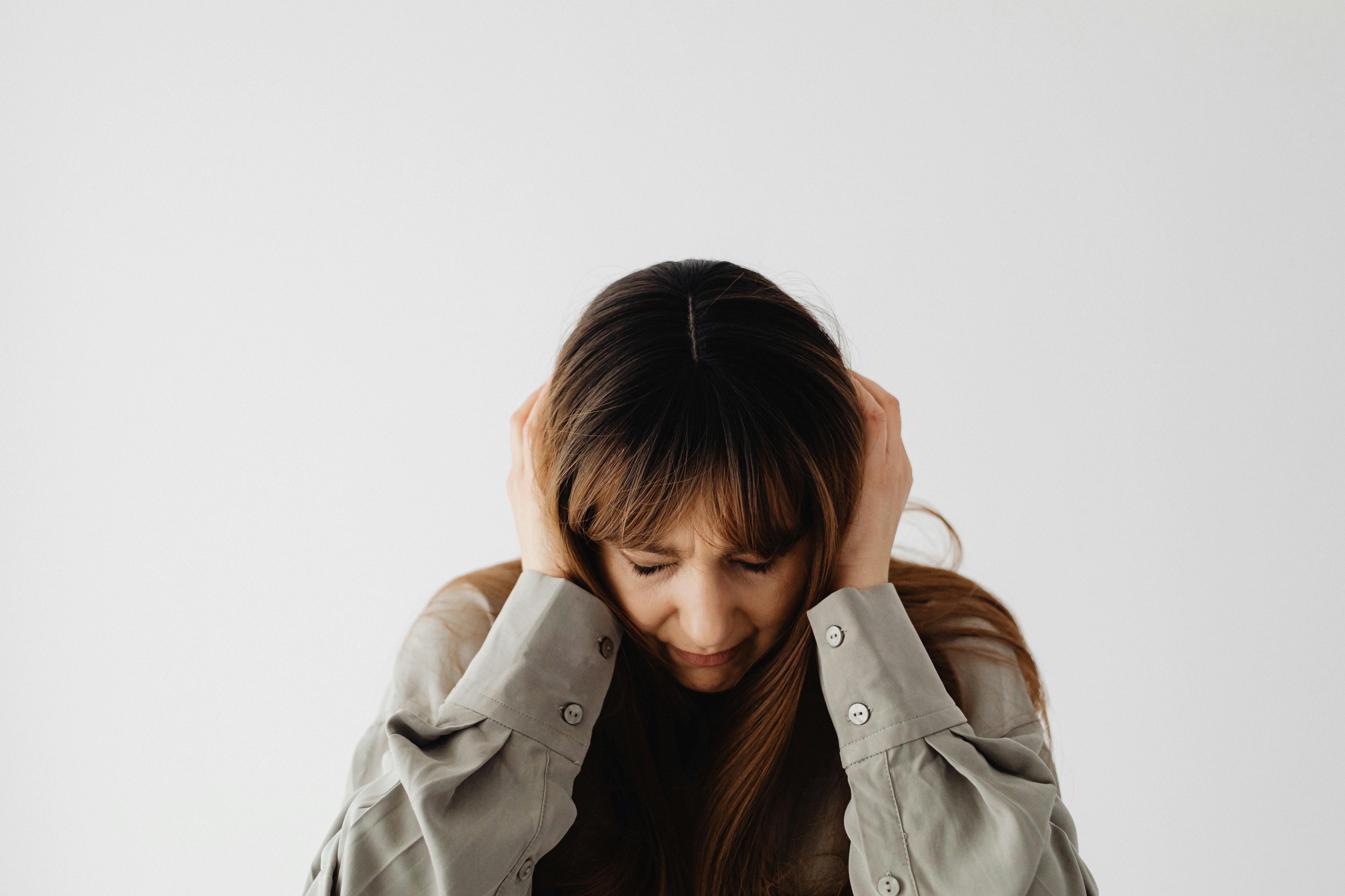 A frustrated woman with her eyes closed | Source: Pexels