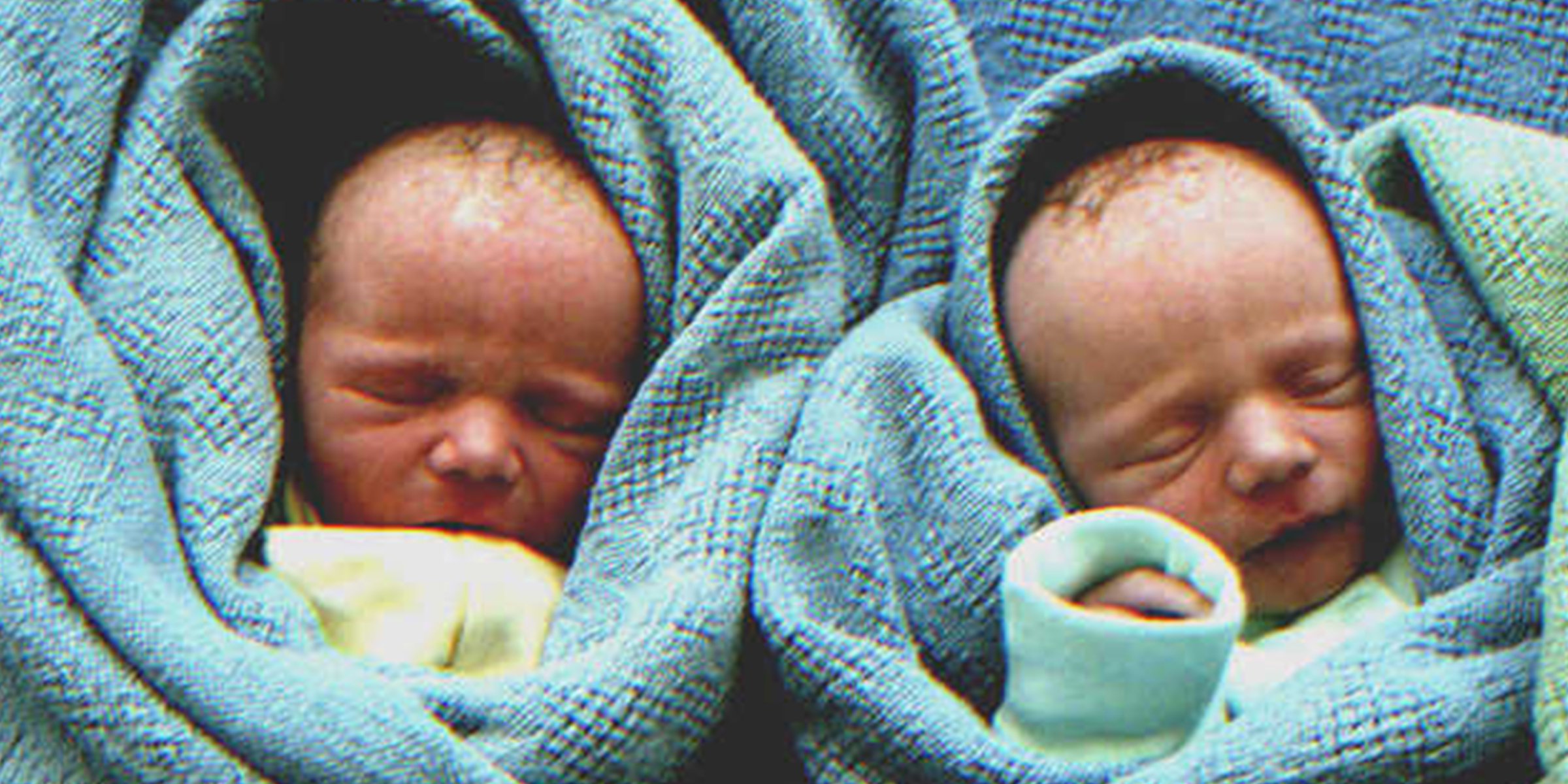 A pair of babies wrapped in a blue blanket | Source: Getty Images