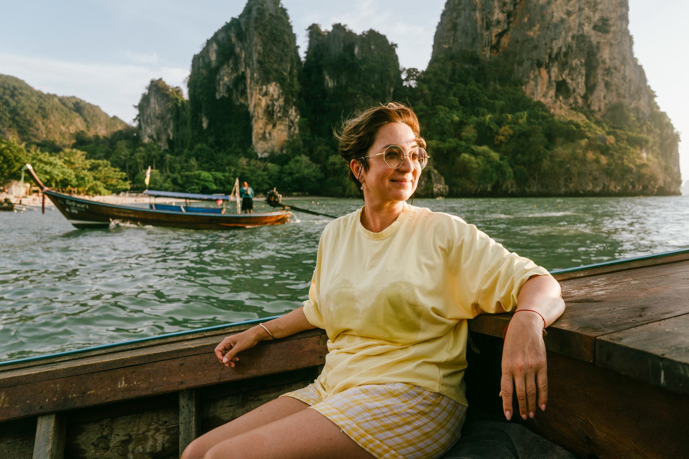 Older woman relaxing on a boat in a scenic location | Source: Getty Images