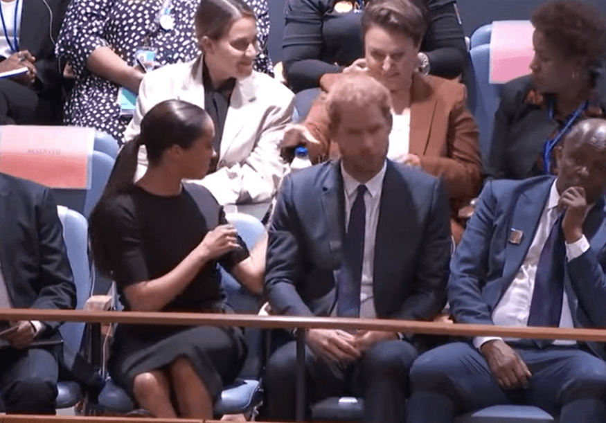 A screengrab of Meghan Markle, Duchess of Sussex, offering a bottle of water to a woman coughing in the second row during the United Nations General Assembly on July 18, 2022 in New York City.┃Source: YouTube/@TheBodyLanguageGuy