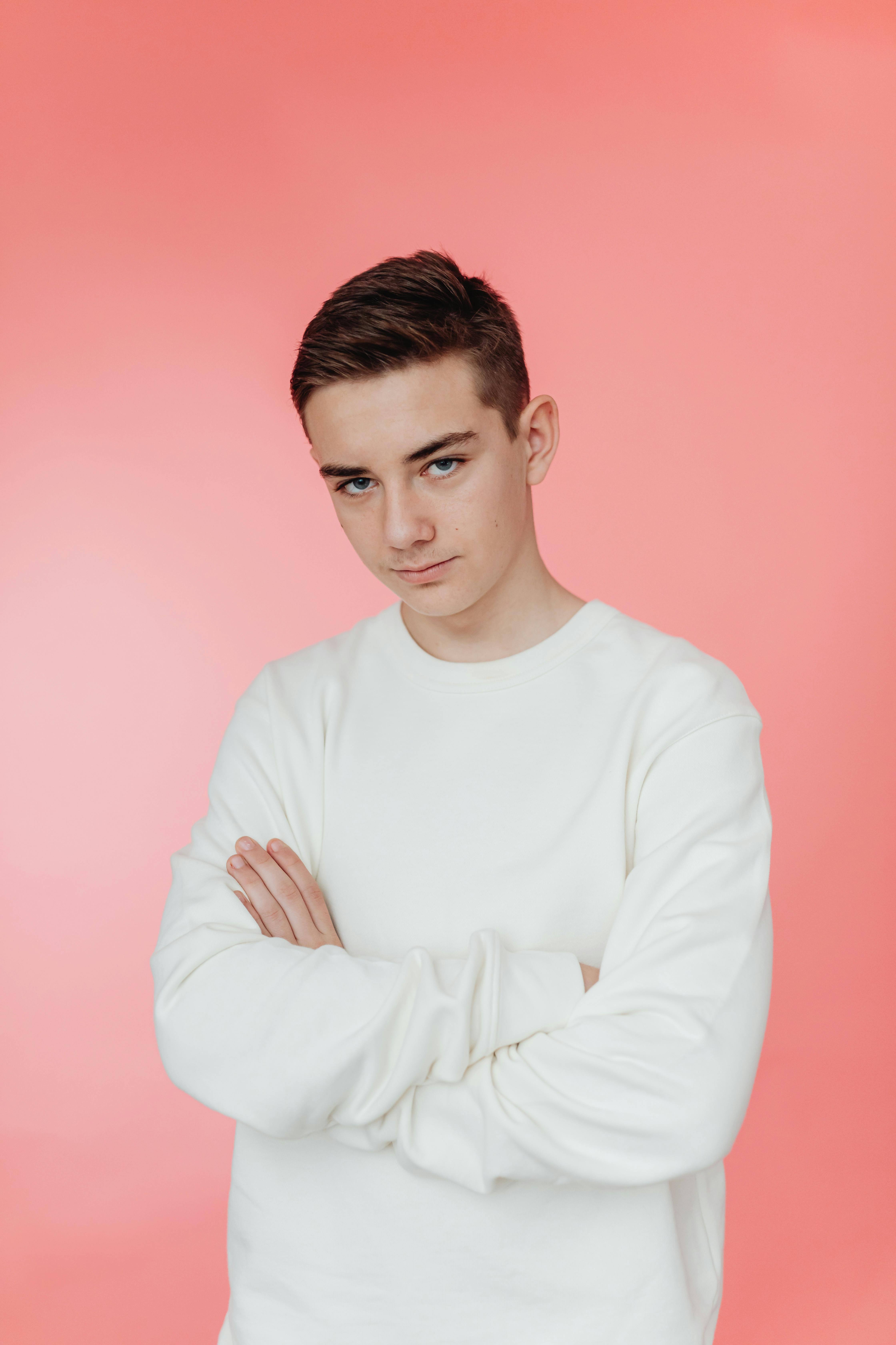 Teenage boy on pink backdrop | Source: Pexels