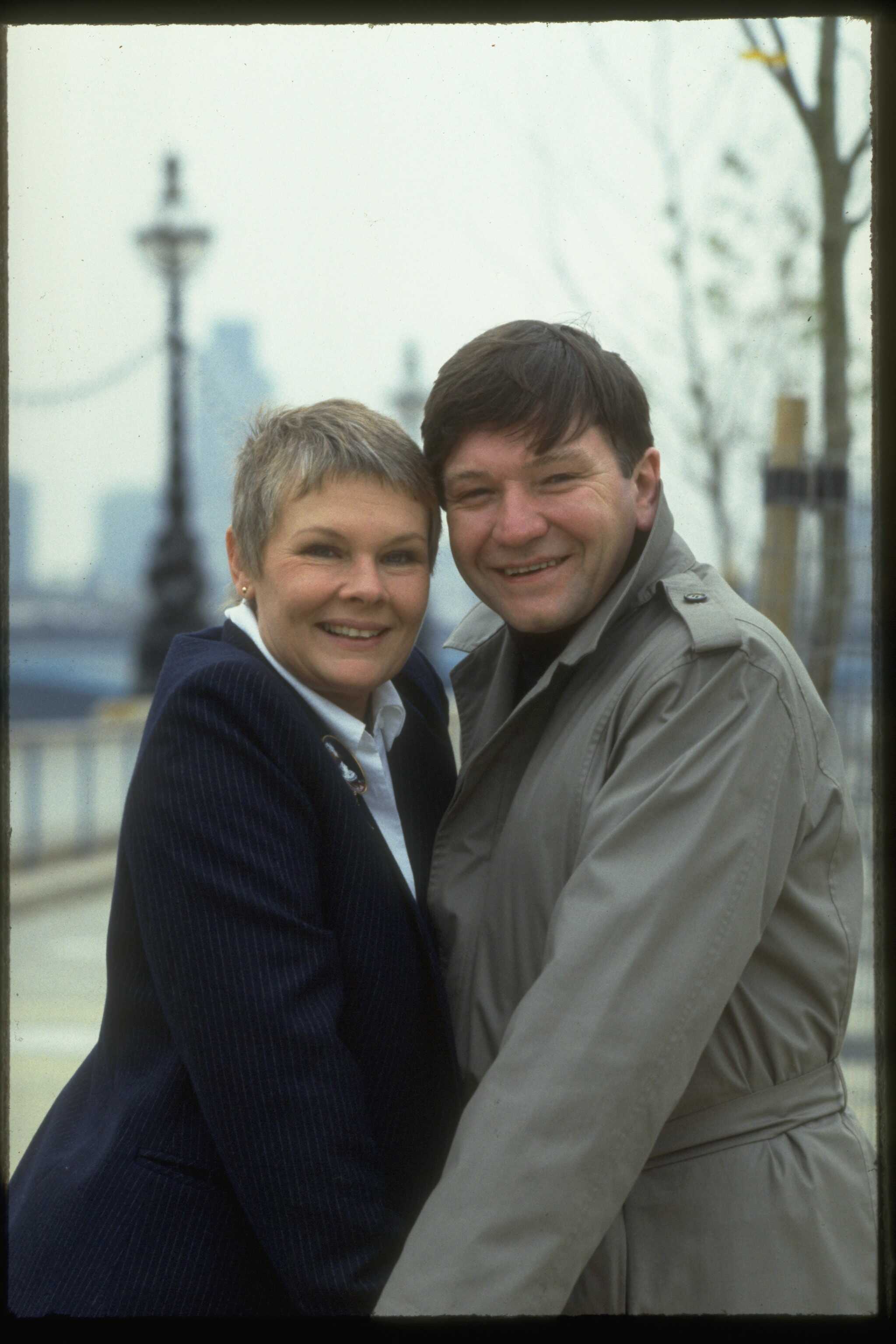 Actor Michael Williams and actress Judi Dench pictured smiling on January 1, 1983 ┃Source: Getty Images