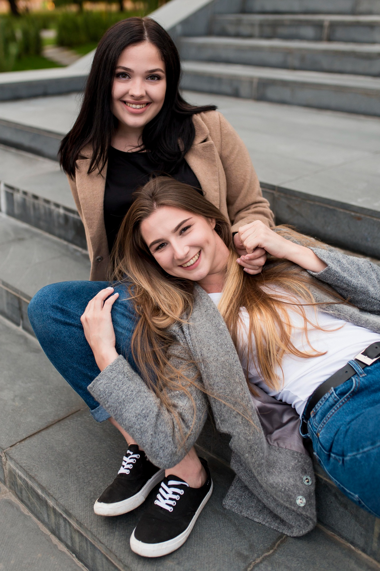 Two happy young women bonding outside on stairs | Source: Freepik