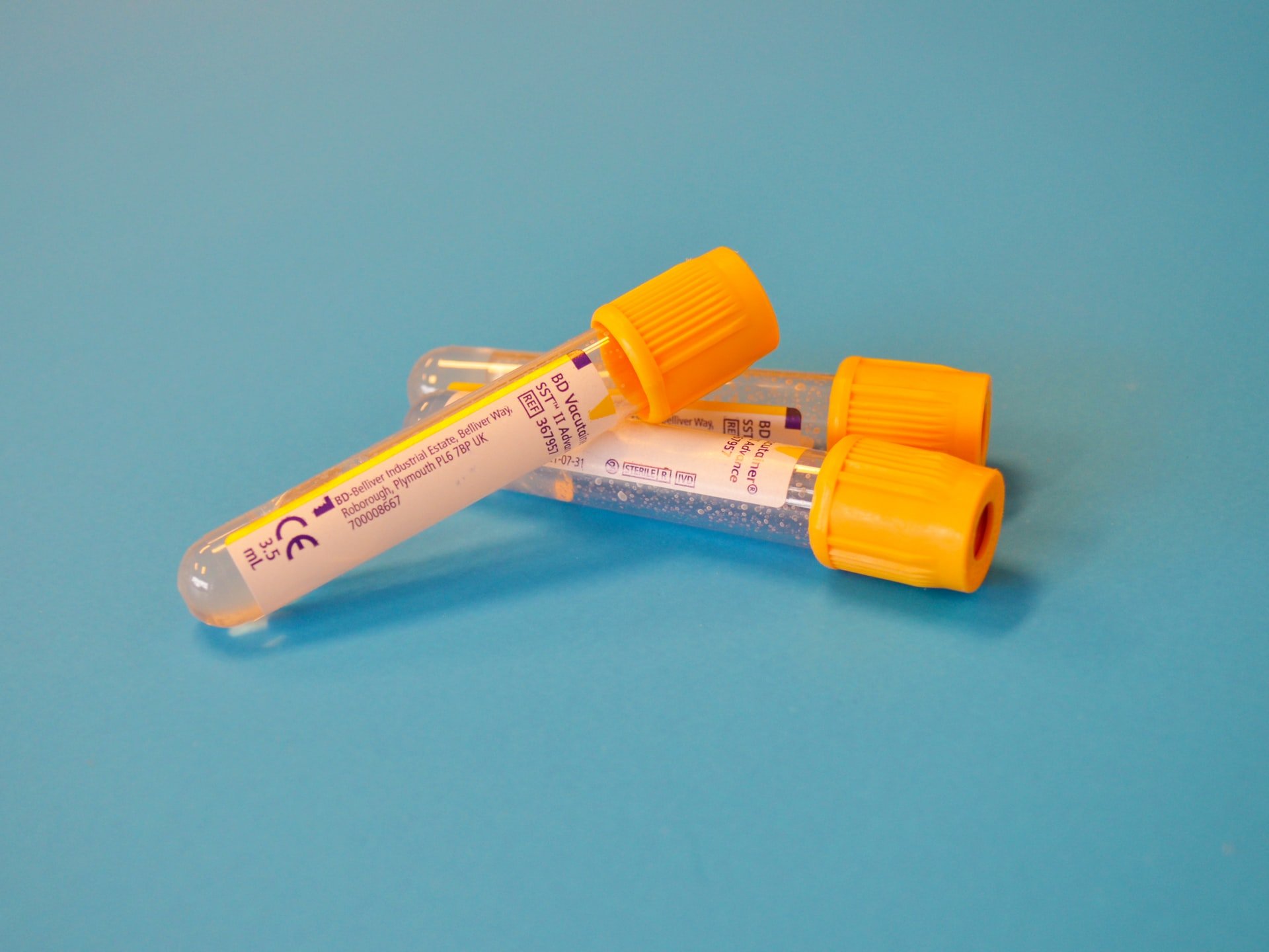 White test tubes with orange caps  | Source: Unsplash