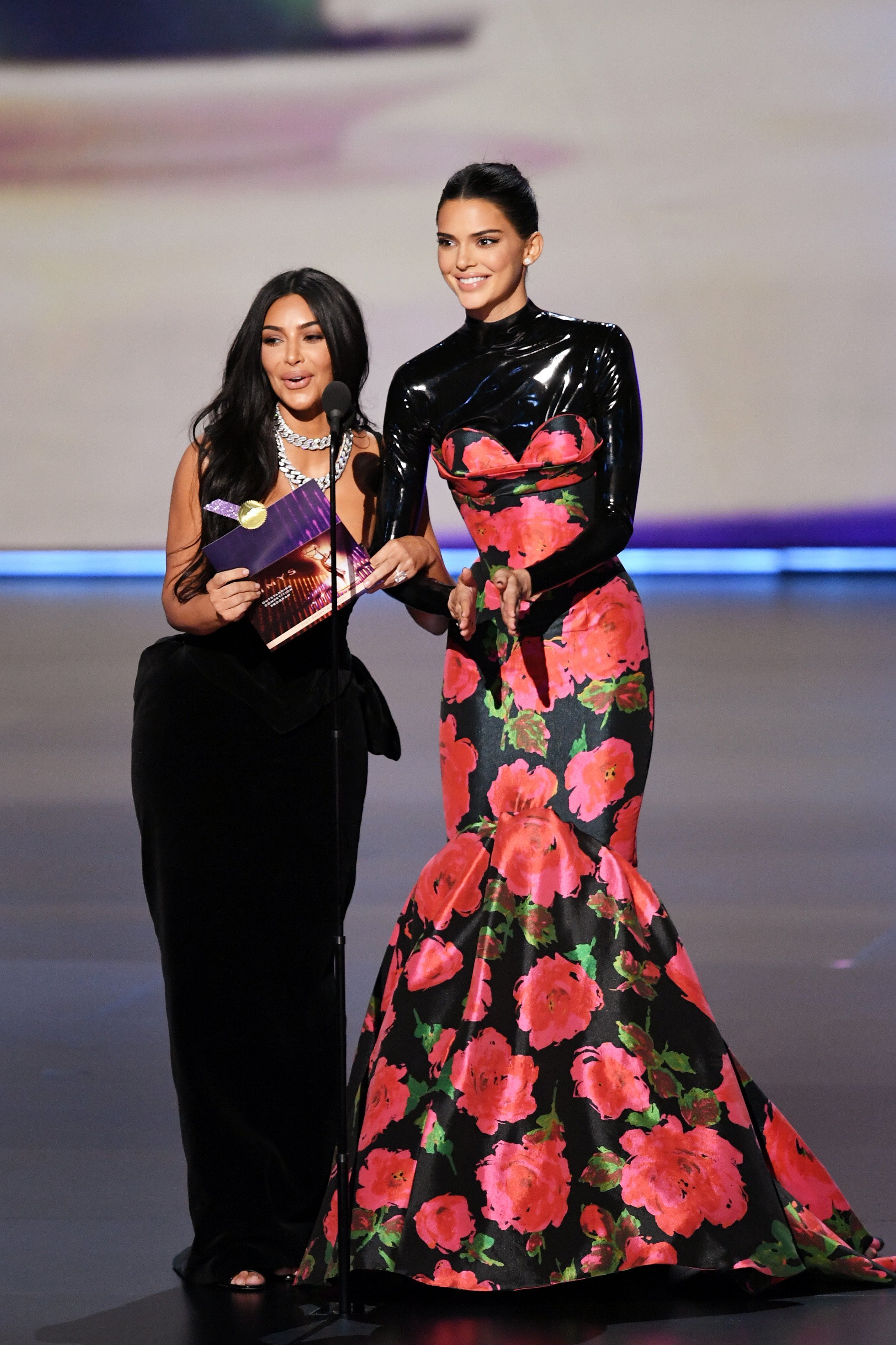 Kim Kardashian West and Kendall Jenner walk onstage during the 71st Emmy Awards. | Source: Getty Images