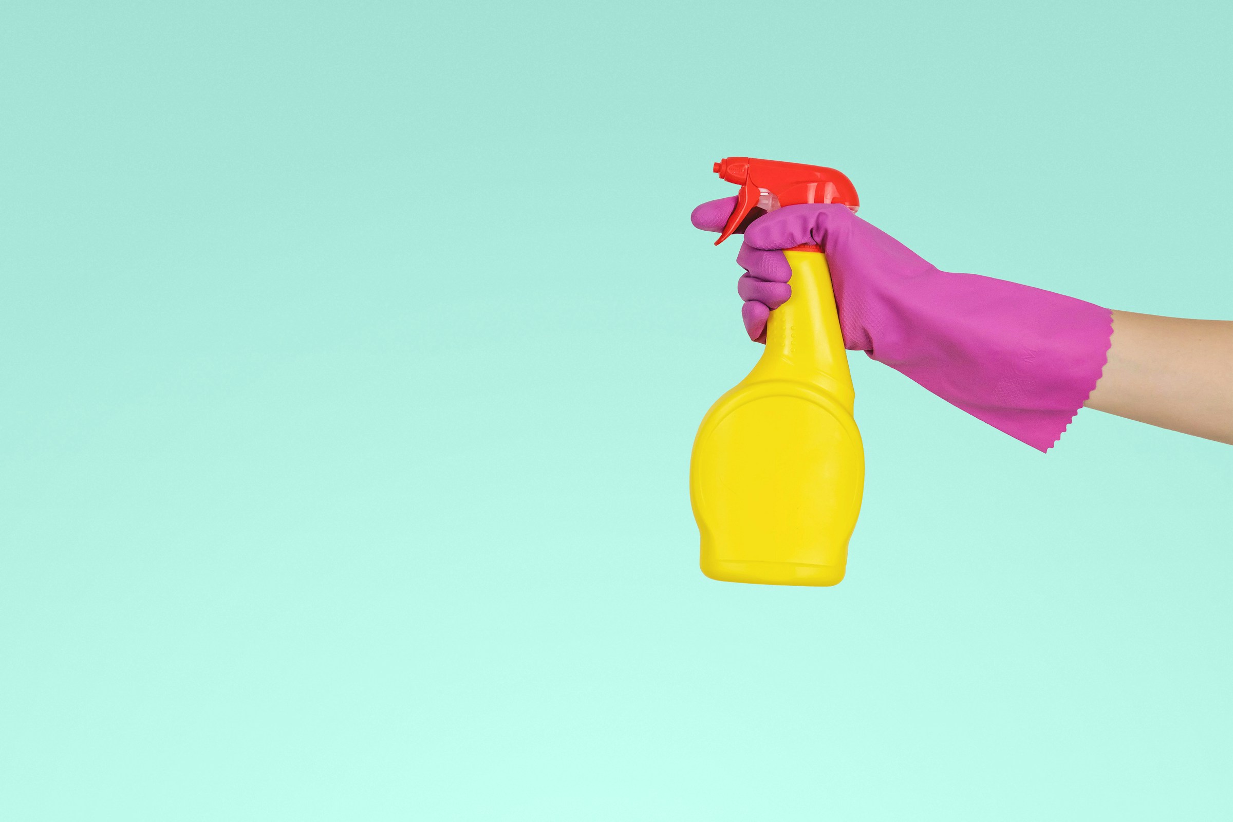 A person holding yellow spray bottle | Source: Unsplash