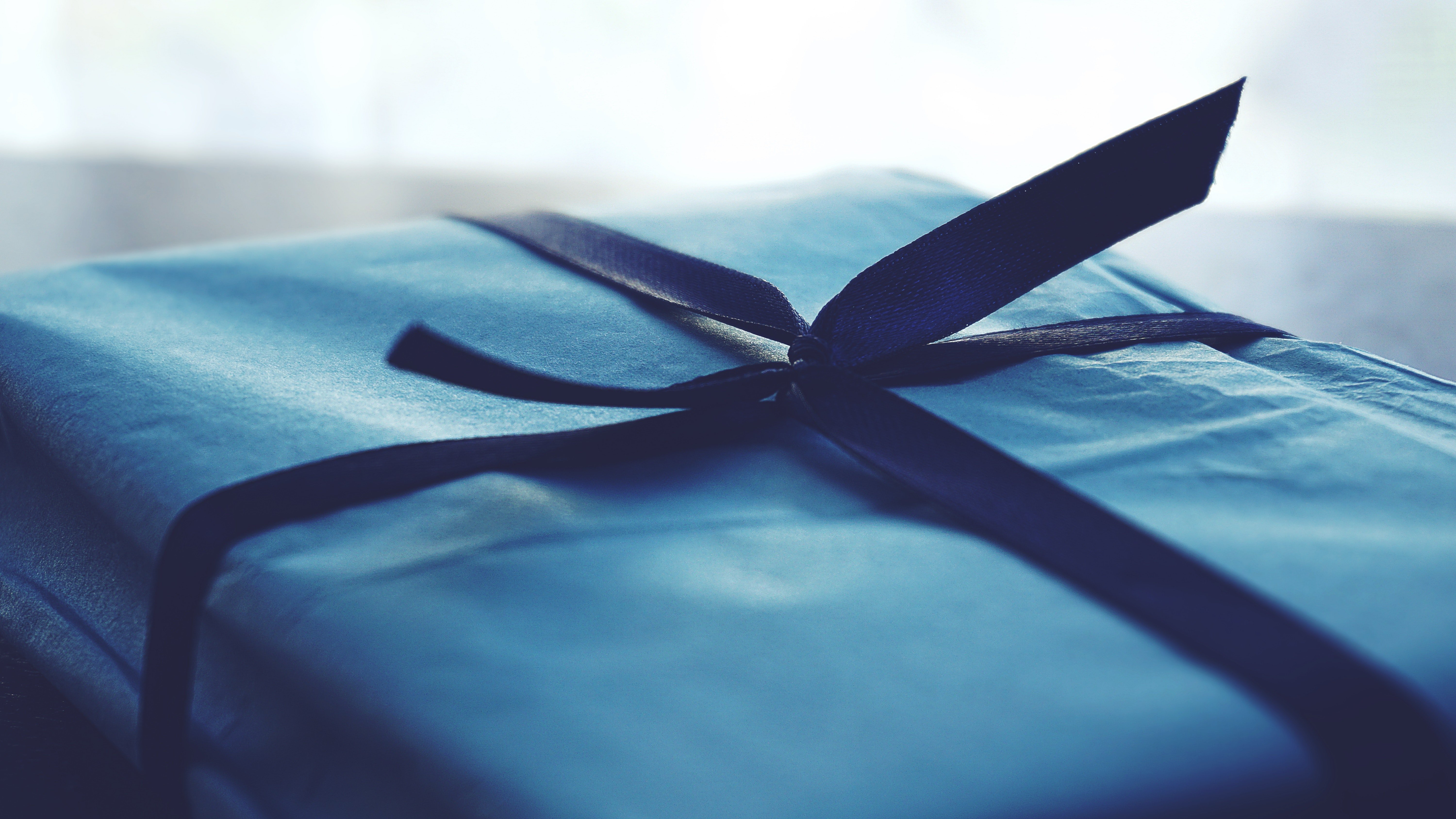 Una caja de regalo azul con un lazo. | Foto: Pexels