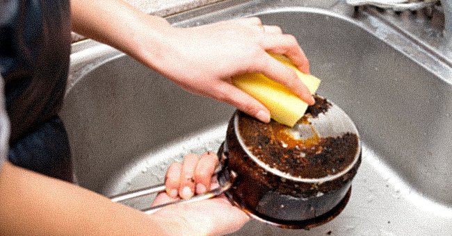 An individual washing a pot. │Source: Shutterstock