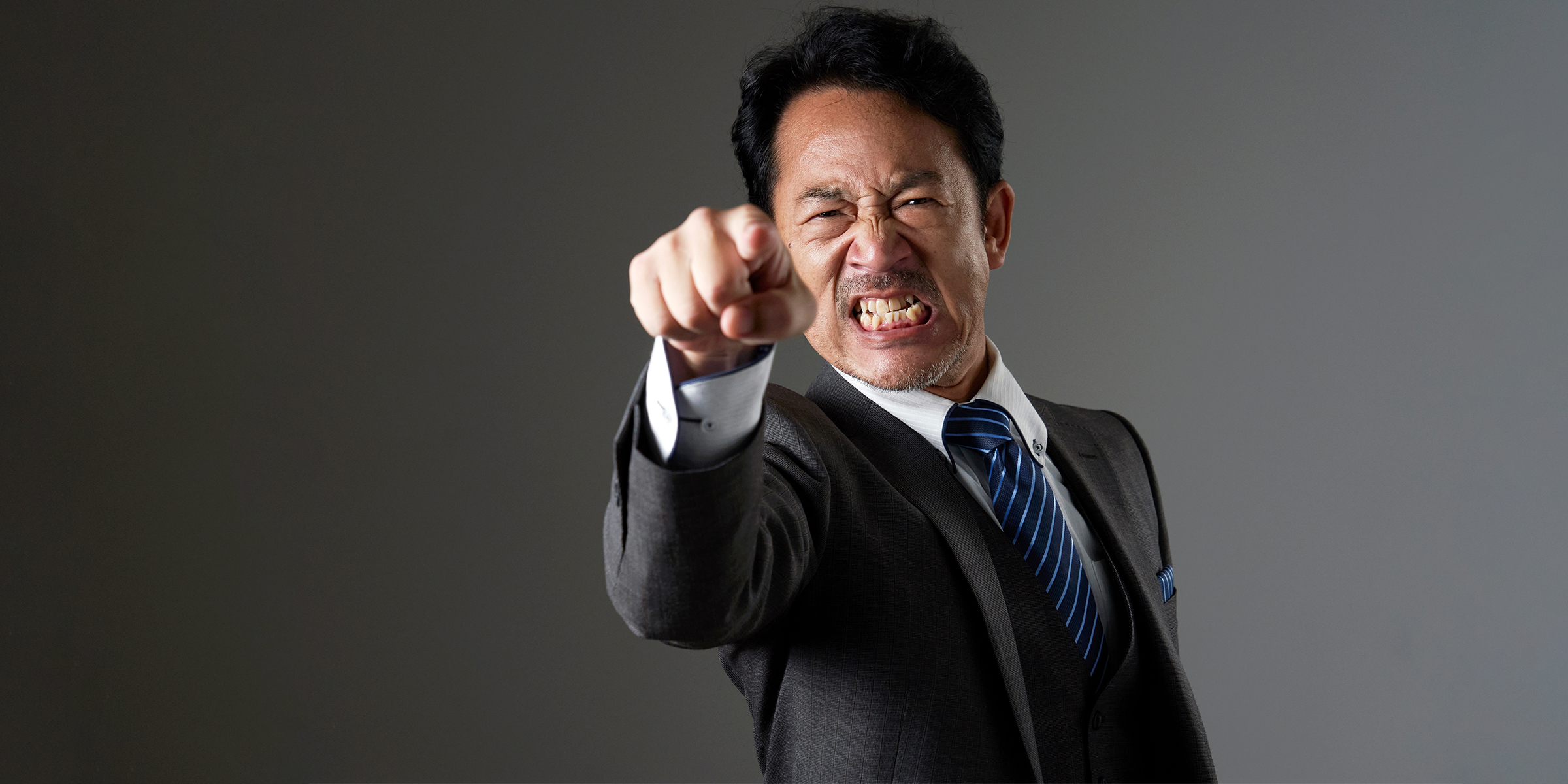 A furious man pointing at someone | Shutterstock