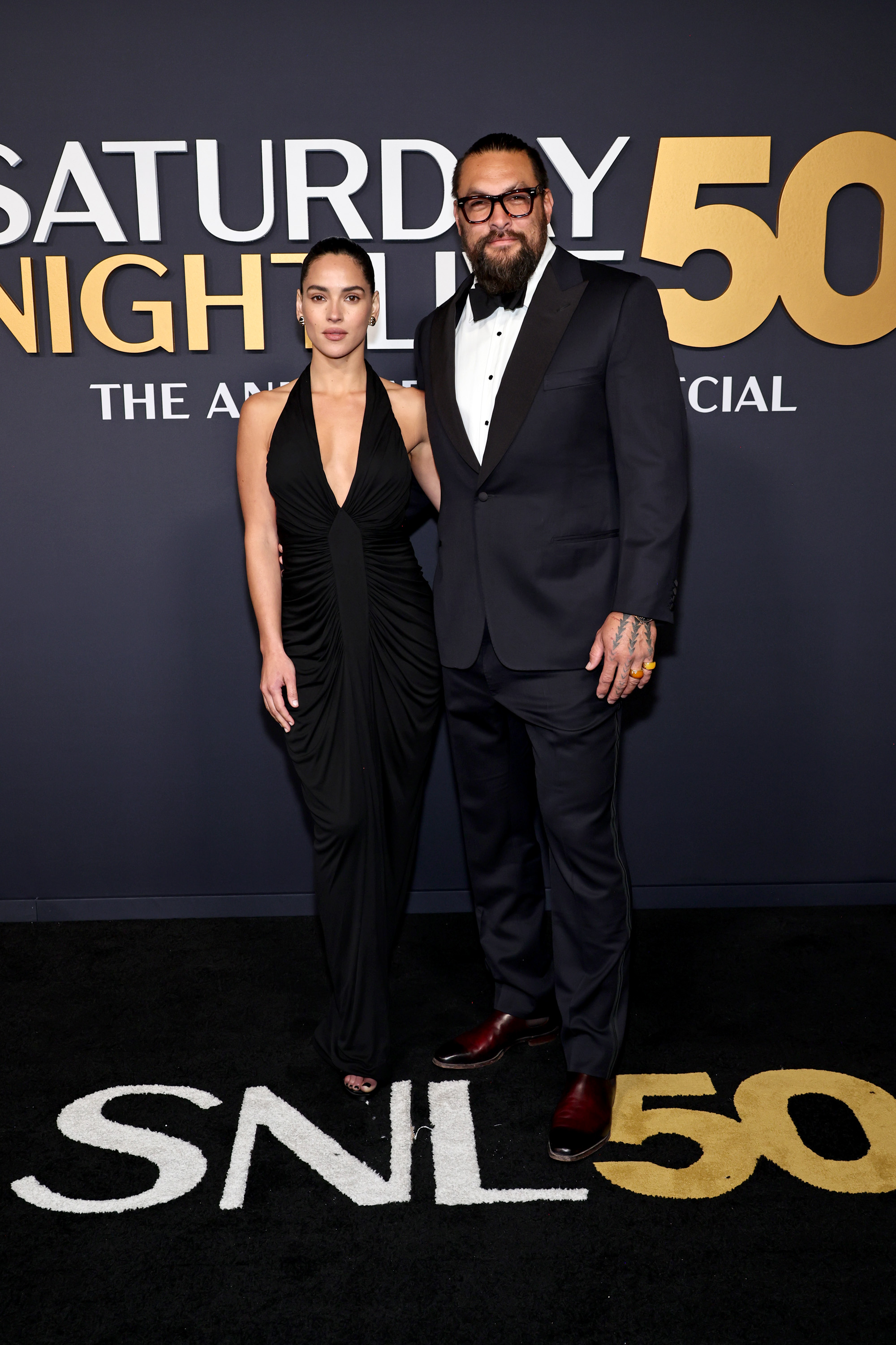 Adria Arjona and Jason Momoa are pictured at "SNL50: The Anniversary Special." | Source: Getty Images