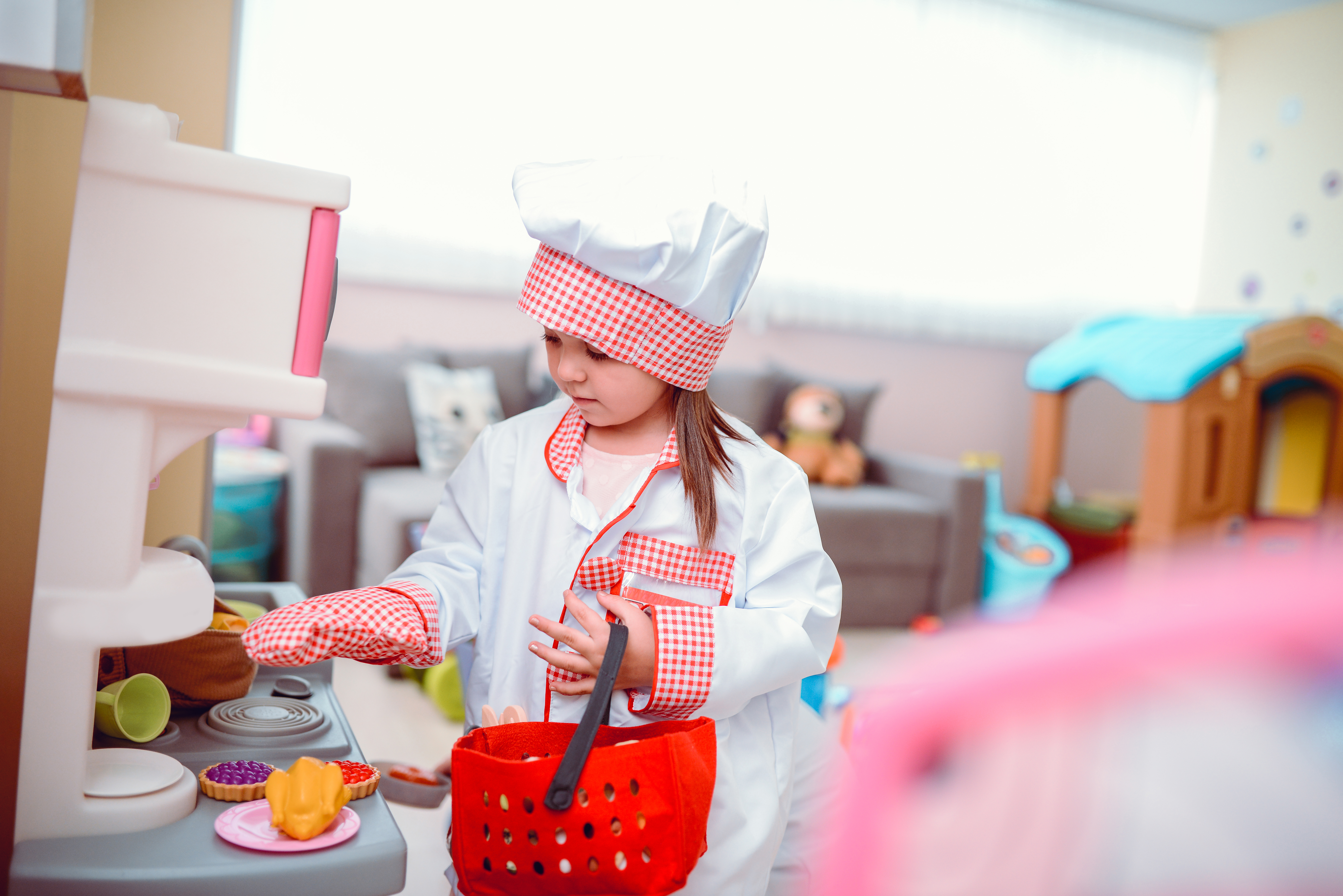 Toddler Girl Playing Cooking Chef in a Preschool Classroom | Source: Getty Images