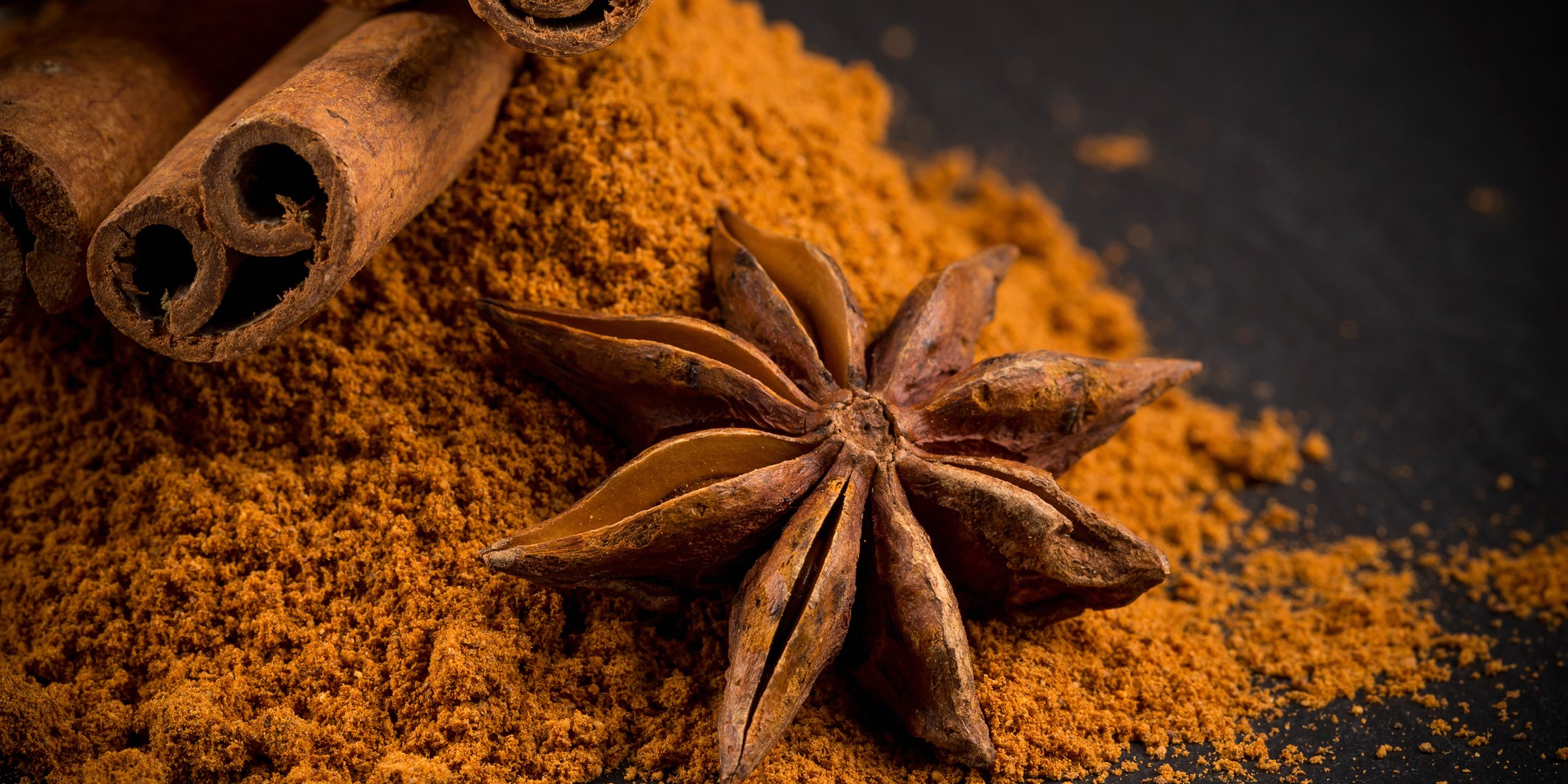 Close photo of cinnamon sticks, powder, and anise | Source: Getty Images