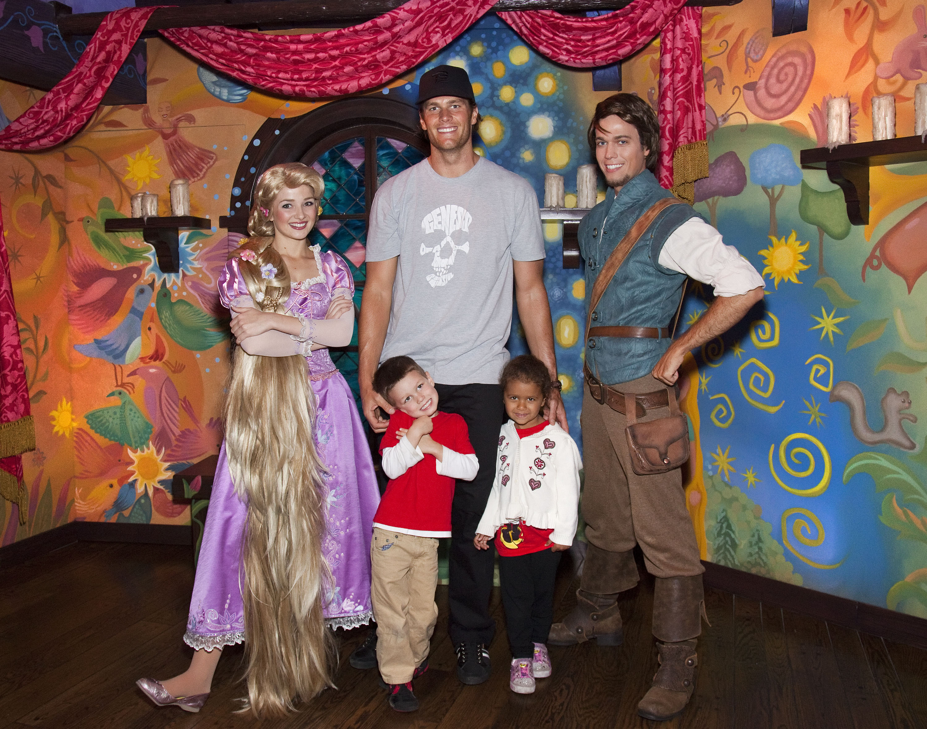 At Disneyland, Tom Brady towers over Jack Moynahan and his niece Jordan as they meet Rapunzel and Flynn Rider from "Tangled." They celebrated Jordan's fifth birthday with a magical family outing.