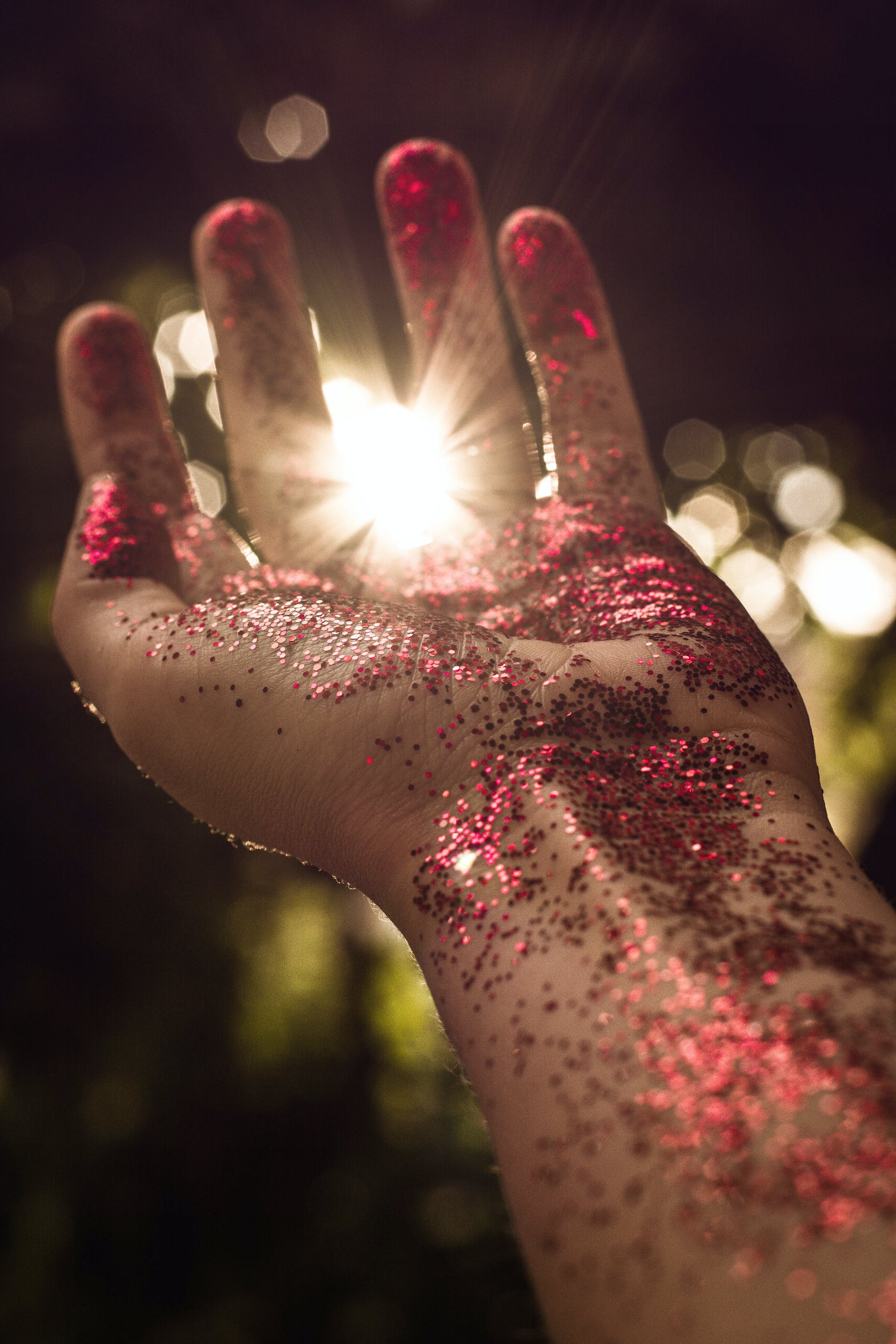 Red glitter on a person's hand | Source: Pexels